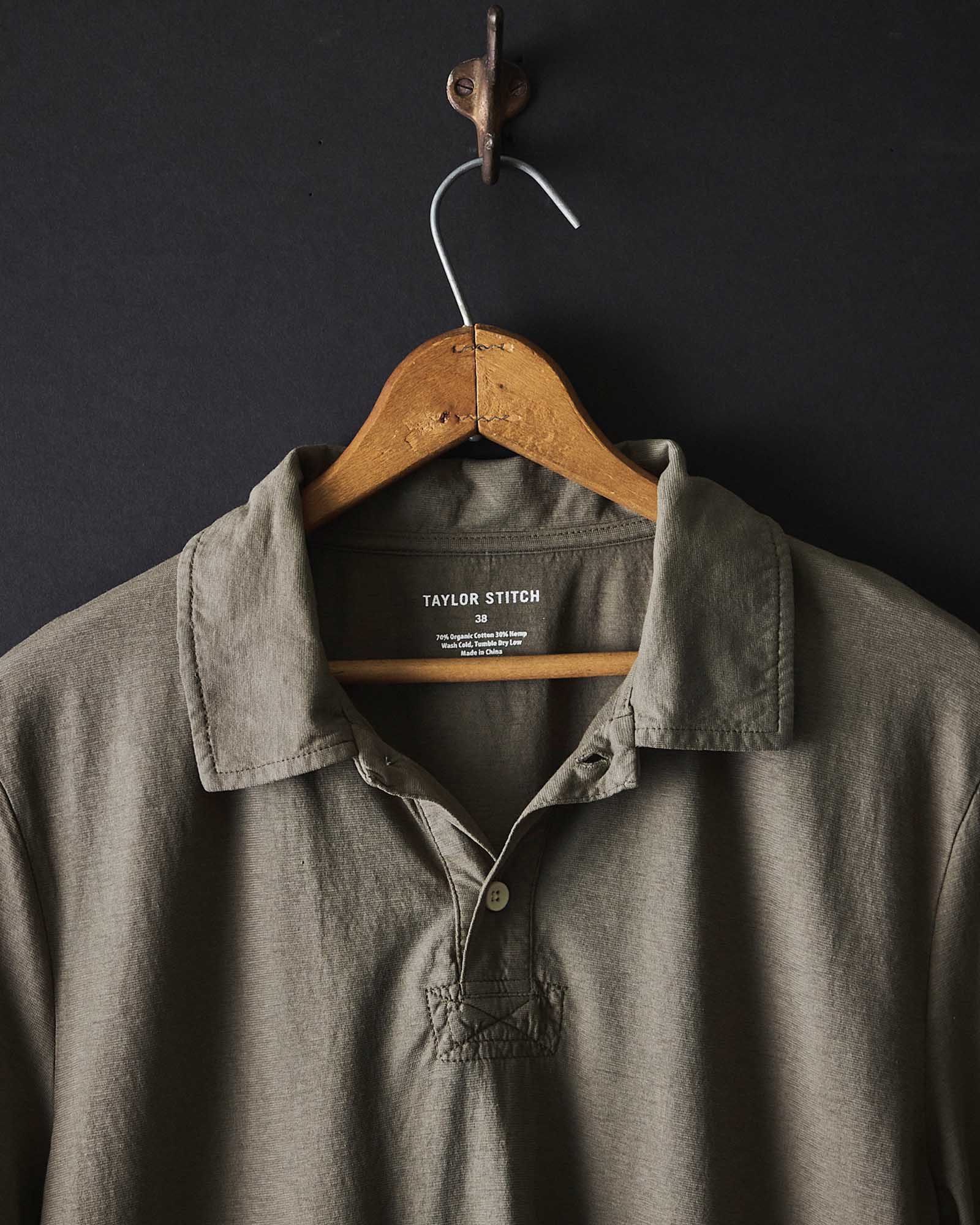 editorial image of The Cotton Hemp Polo in Olive hanging, Knits by Taylor Stitch