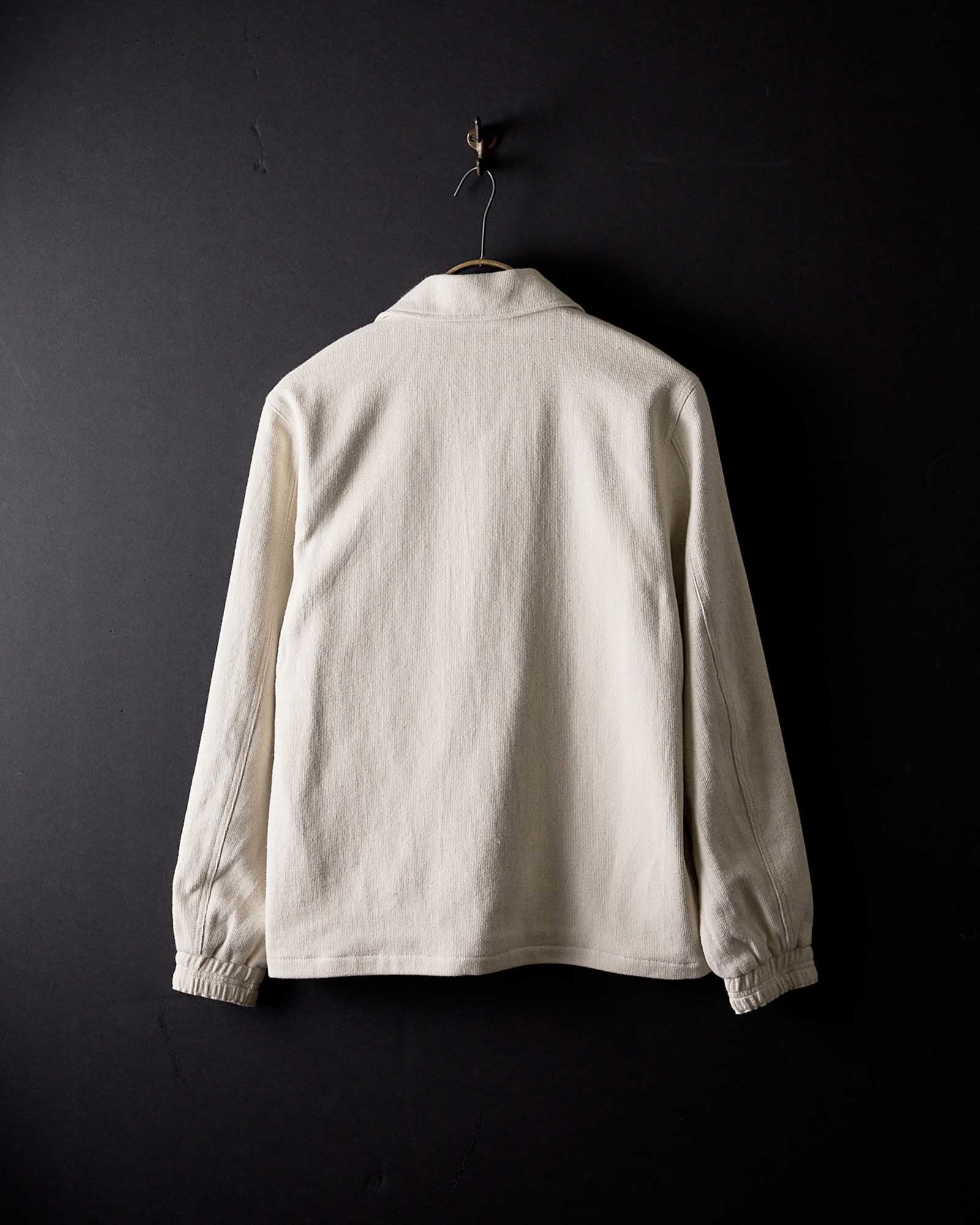 editorial image of the back of The Crew Jacket in Seeded Natural Sashiko hanging, Outerwear by Taylor Stitch