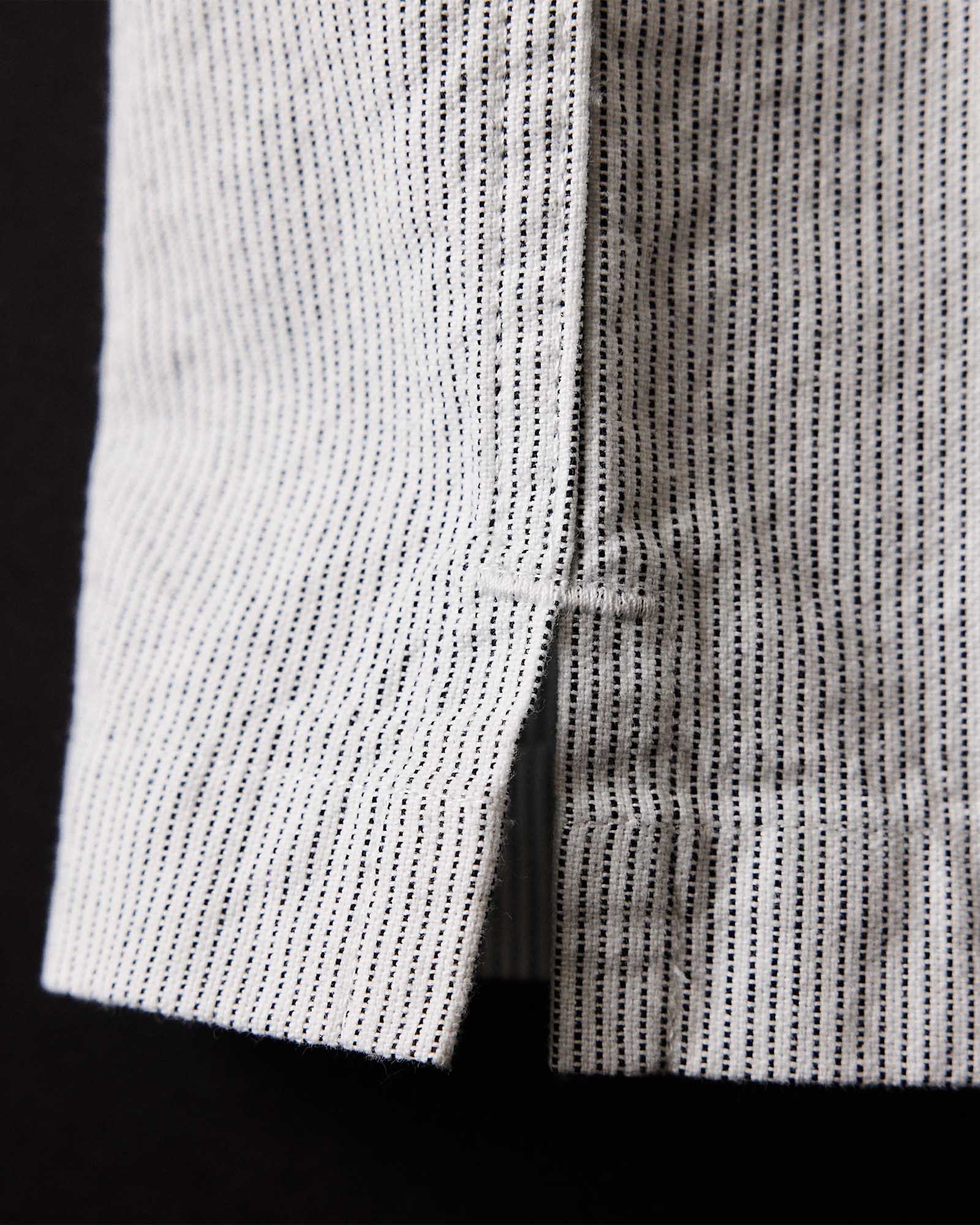 material shot of the bottom hem on The Exhaust Shirt in Natural Stripe, Wovens by Taylor Stitch