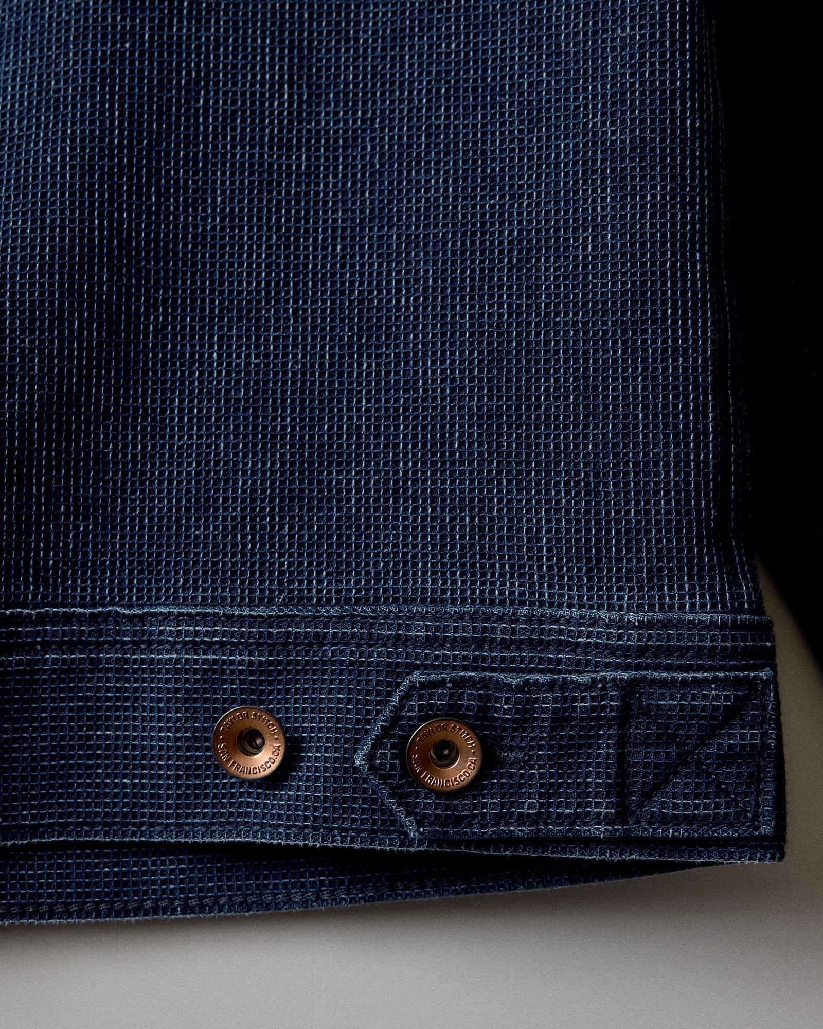 close up of the adjustable back tabs on The Long Haul Jacket in Rinsed Indigo Waffle, Outerwear by Taylor Stitch