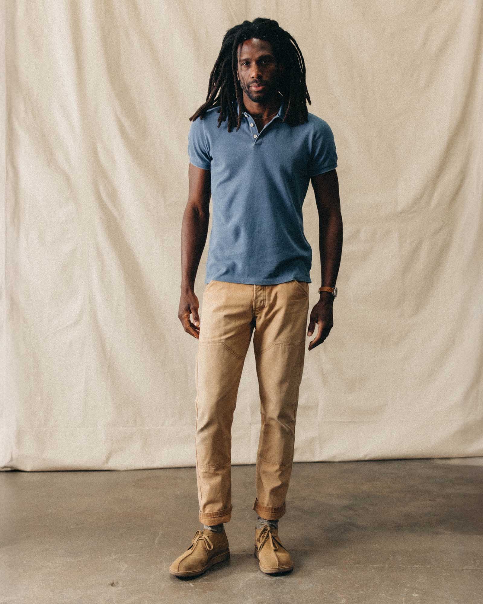 fit model posing in The Pacific Polo in Washed Indigo Pique, Knits by Taylor Stitch