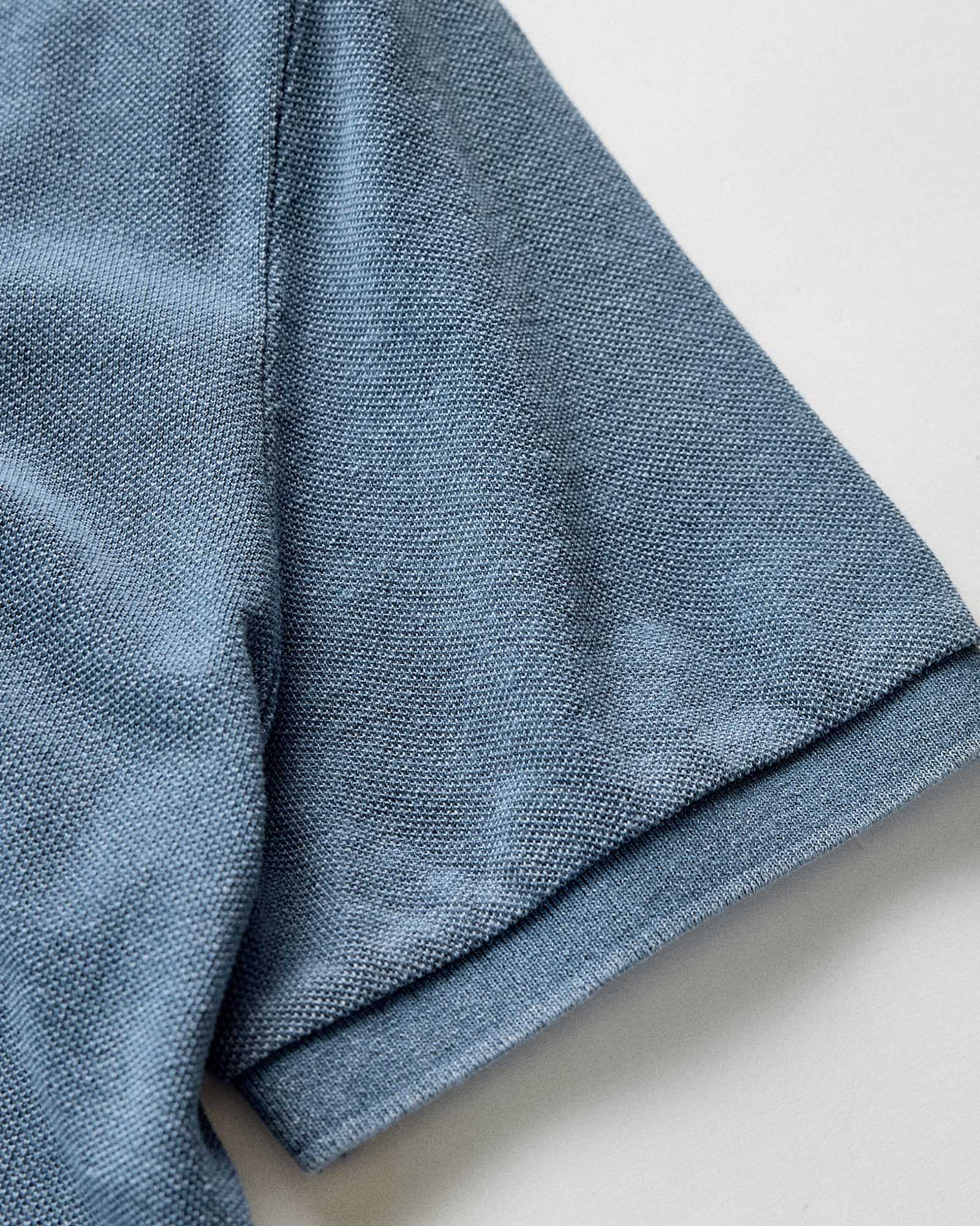 material shot of the sleeve on The Pacific Polo in Washed Indigo Pique, Knits by Taylor Stitch
