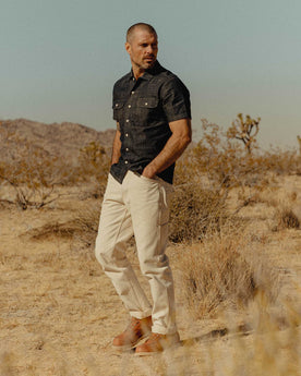 fit model walking wearing The Painter Pant in Seeded Natural Chipped Canvas, Bottoms by Taylor Stitch