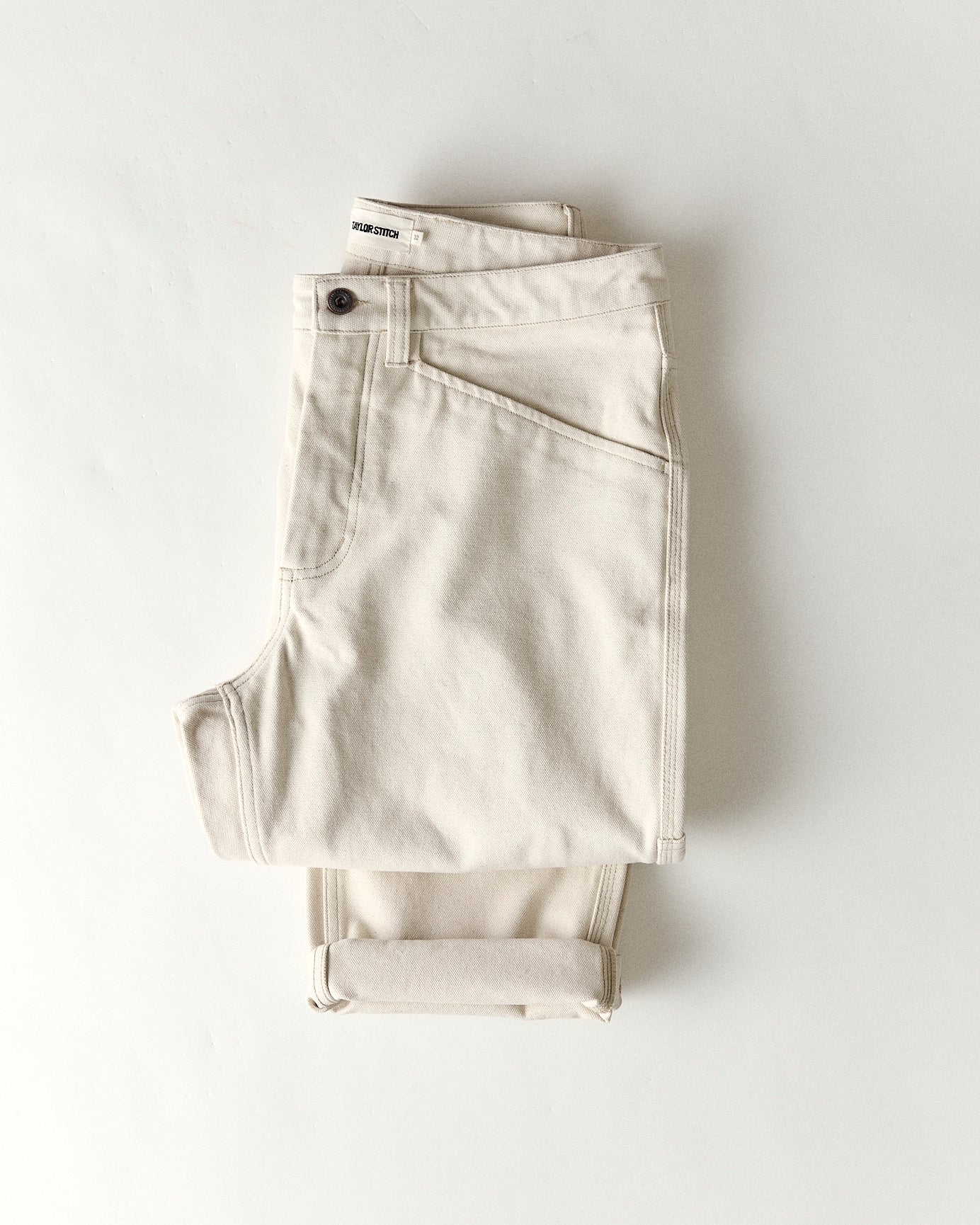 folded flatlay of the back of The Painter Pant in Seeded Natural Chipped Canvas, Bottoms by Taylor Stitch