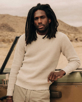 fit model leaning against a car wearing The Ranger Sweater in Heather Fog Linen Waffle, Knits by Taylor Stitch