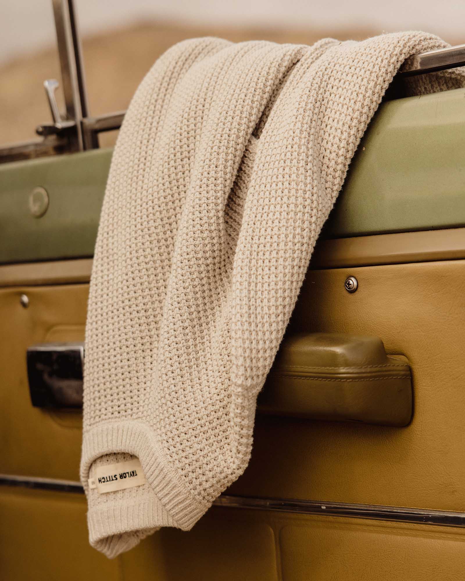 editorial image of The Ranger Sweater in Heather Fog Linen Waffle hanging on a car, Knits by Taylor Stitch