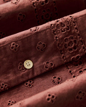 material shot of the buttons and eyelet on The Hawthorne Shirt in Red Wine Border Eyelet, Wovens by Taylor Stitch