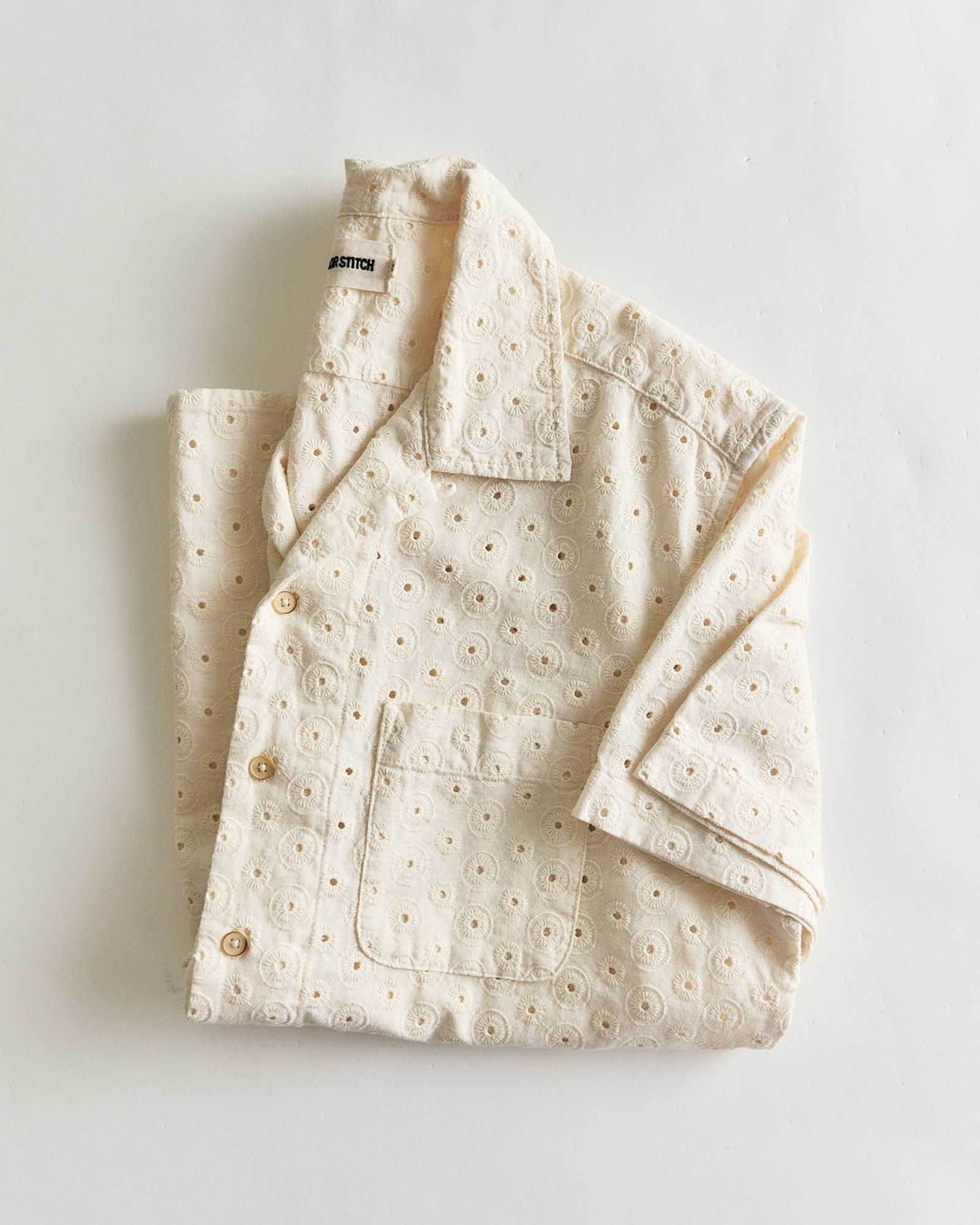 folded flatlay of The Hawthorne Shirt in Vintage White Embroidered Eyelet, Wovens by Taylor Stitch