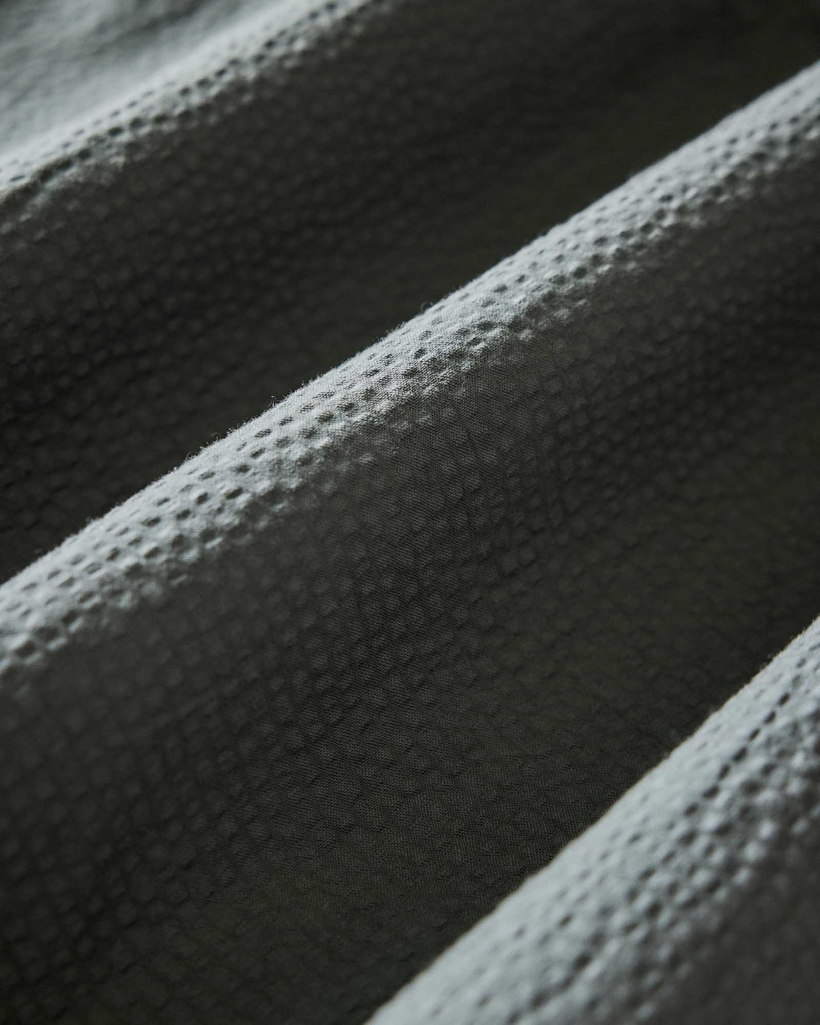 material shot of the seersucker on The Short Sleeve Jack in Deep Sea Seersucker, Wovens by Taylor Stitch