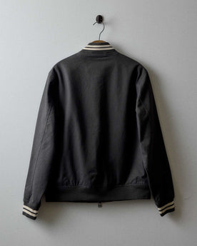 editorial image of the back of The Speedway Bomber in Organic Faded Black Twill hanging, Outerwear by Taylor Stitch