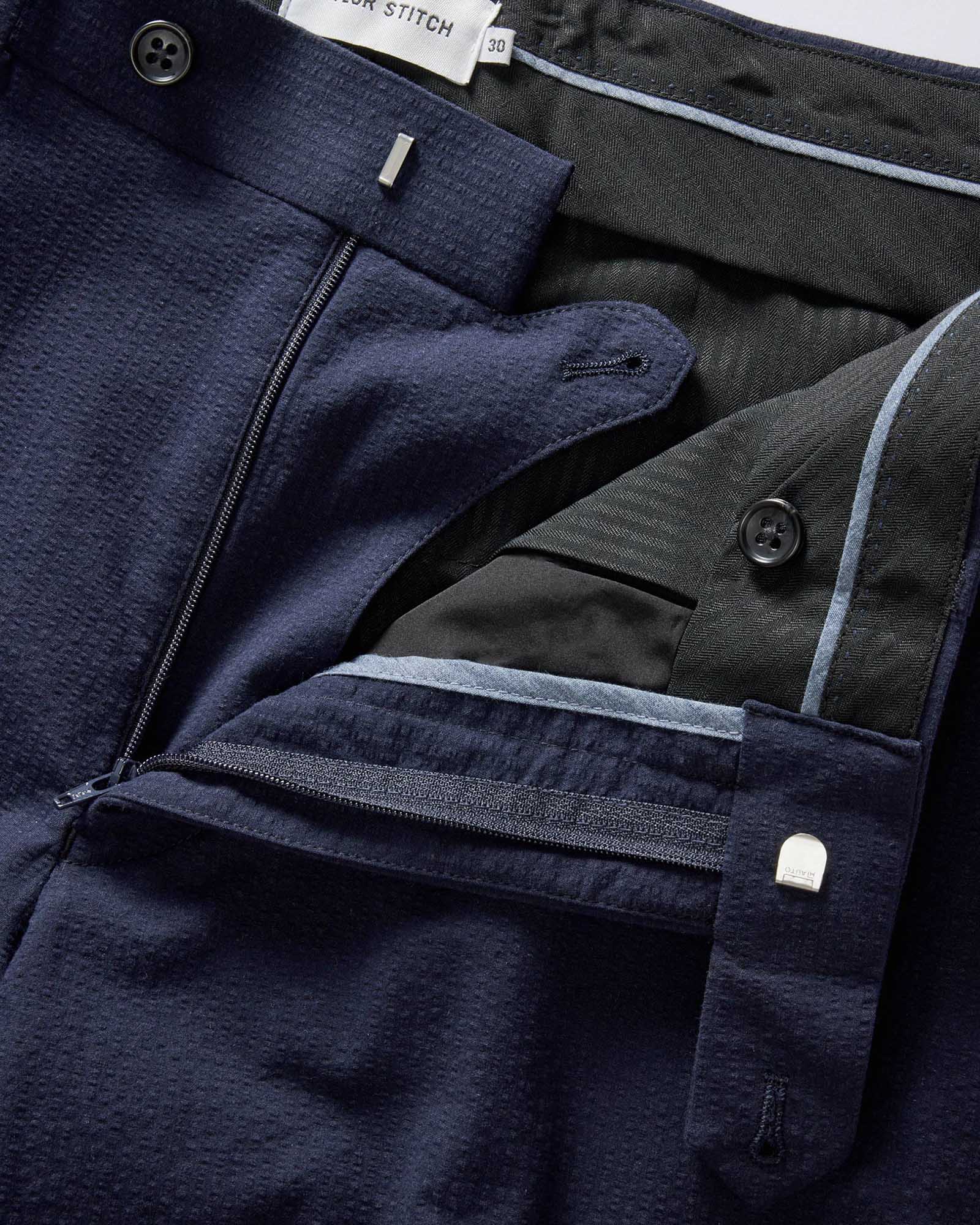 material shot of the zipper fly on The Stevens Trouser in Navy Linen Seersucker, Bottoms by Taylor Stitch