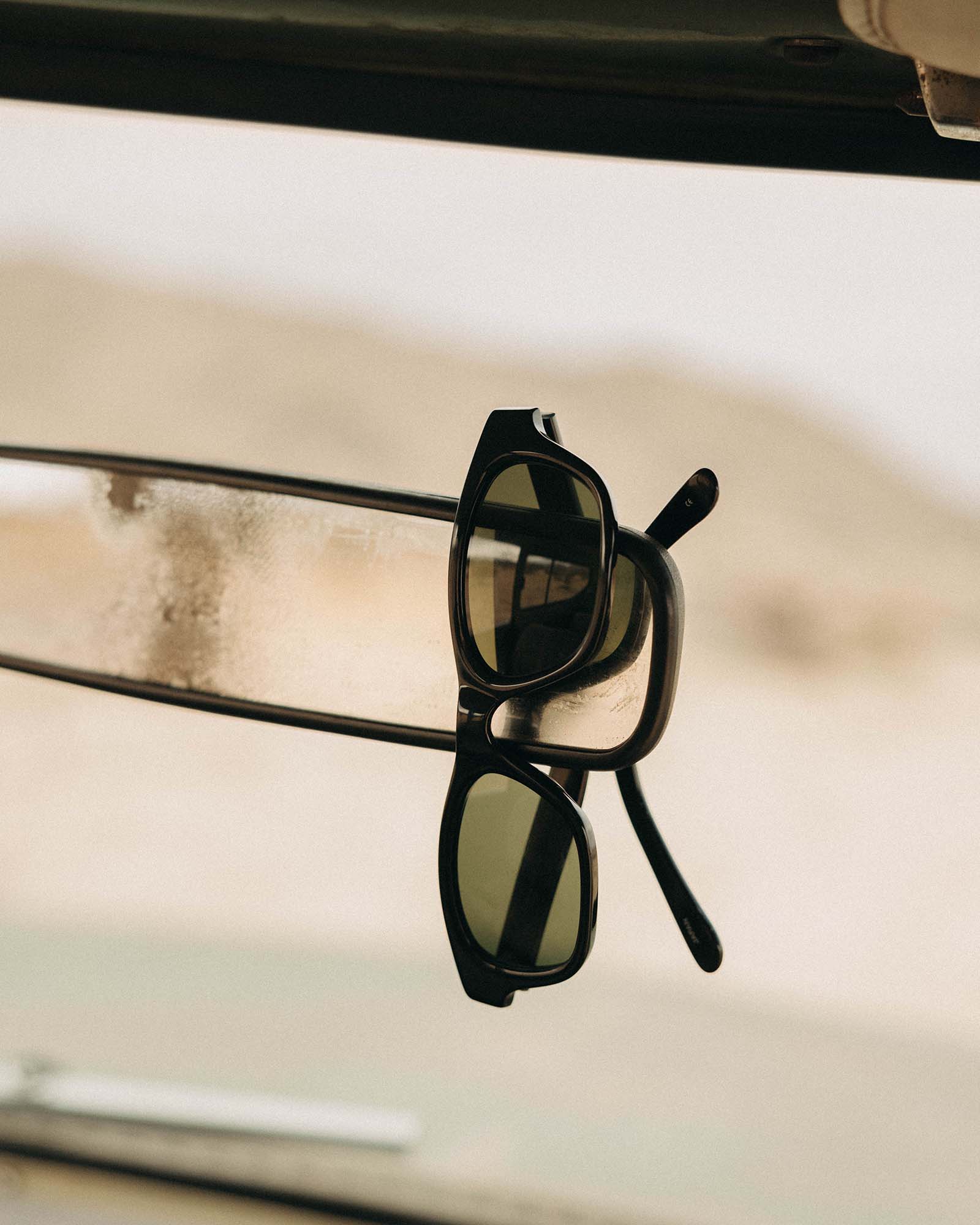 editorial image of The Sergio in Black hanging on a rearview mirror, Accessories by Taylor Stitch