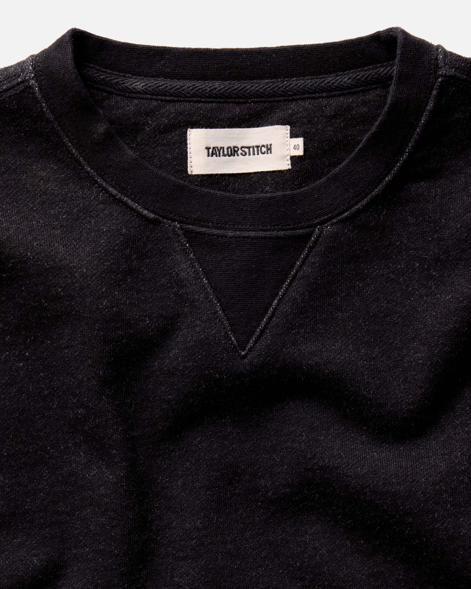 fit model with his arms crossed wearing The Apres Crew in Black Indigo Terry, Knits by Taylor Stitch