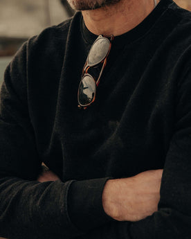 fit model with his arms crossed wearing The Apres Crew in Black Indigo Terry, Knits by Taylor Stitch