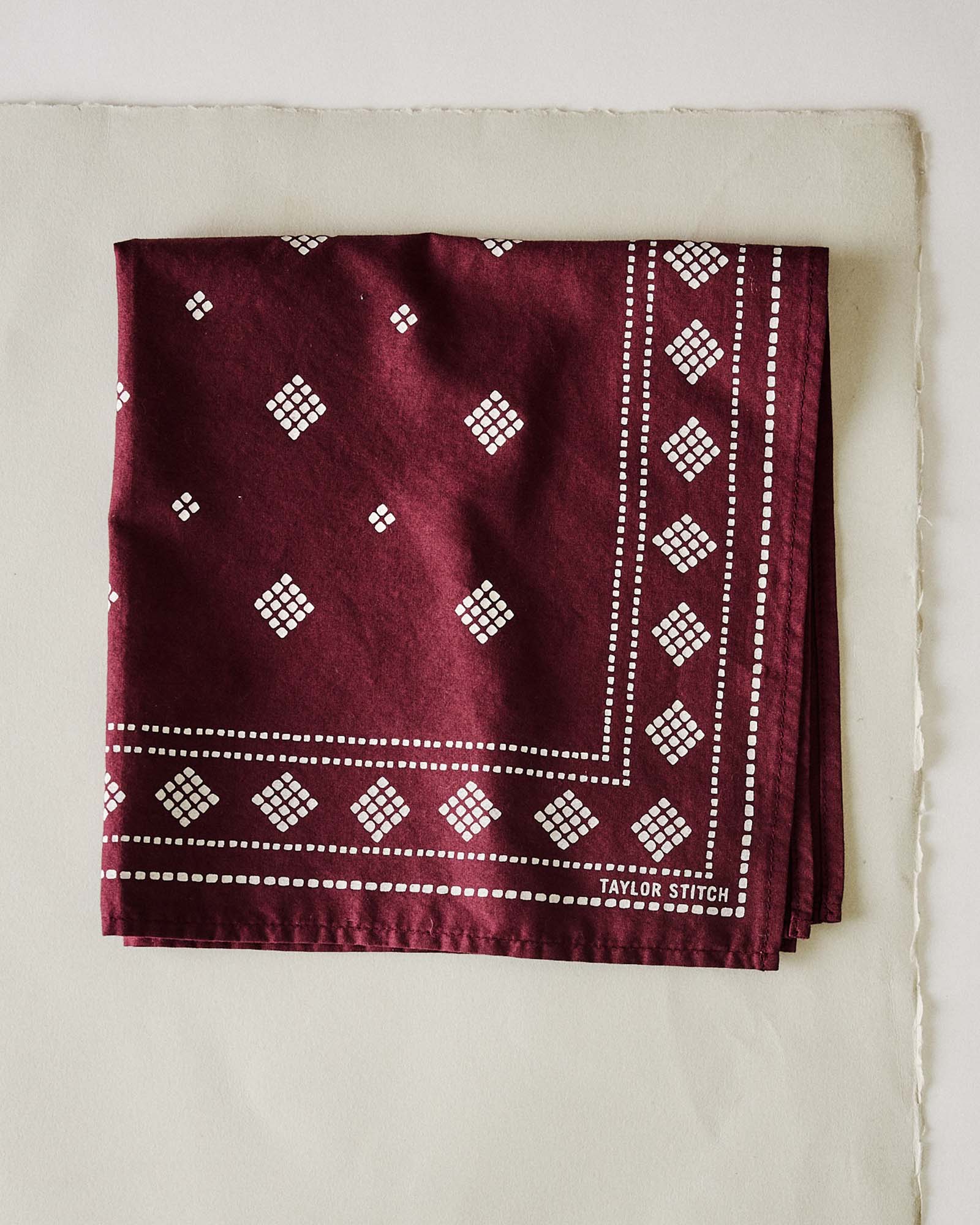 folded flatlay of The Bandana in Dried Cherry Diamond, Accessories by Taylor Stitch