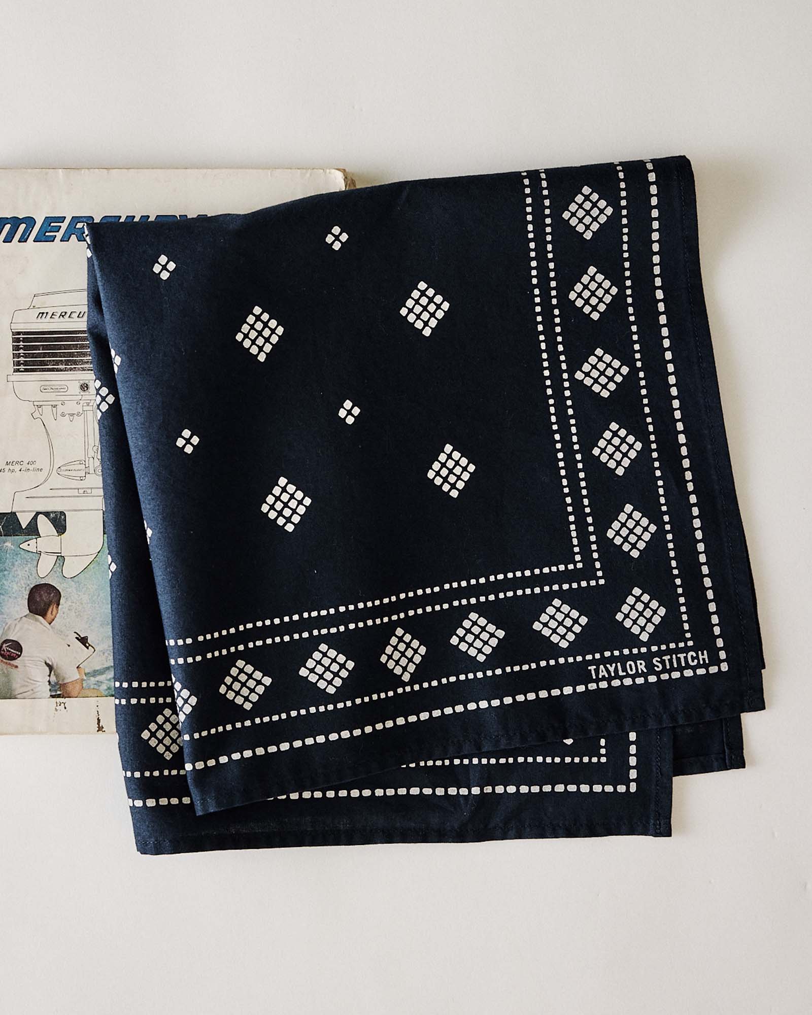 editorial image of The Bandana in Navy Diamond folded, Accessories by Taylor Stitch