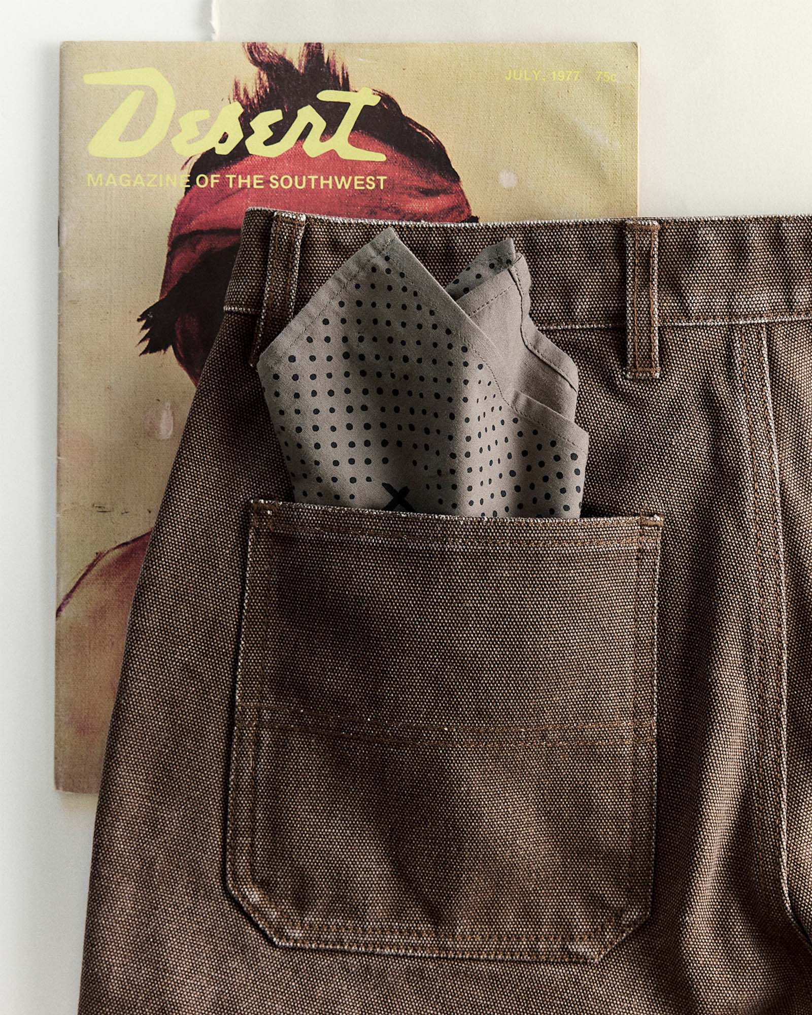 editorial image of The Bandana in Smoked Olive Pindot in a pants pocket, Accessories by Taylor Stitch
