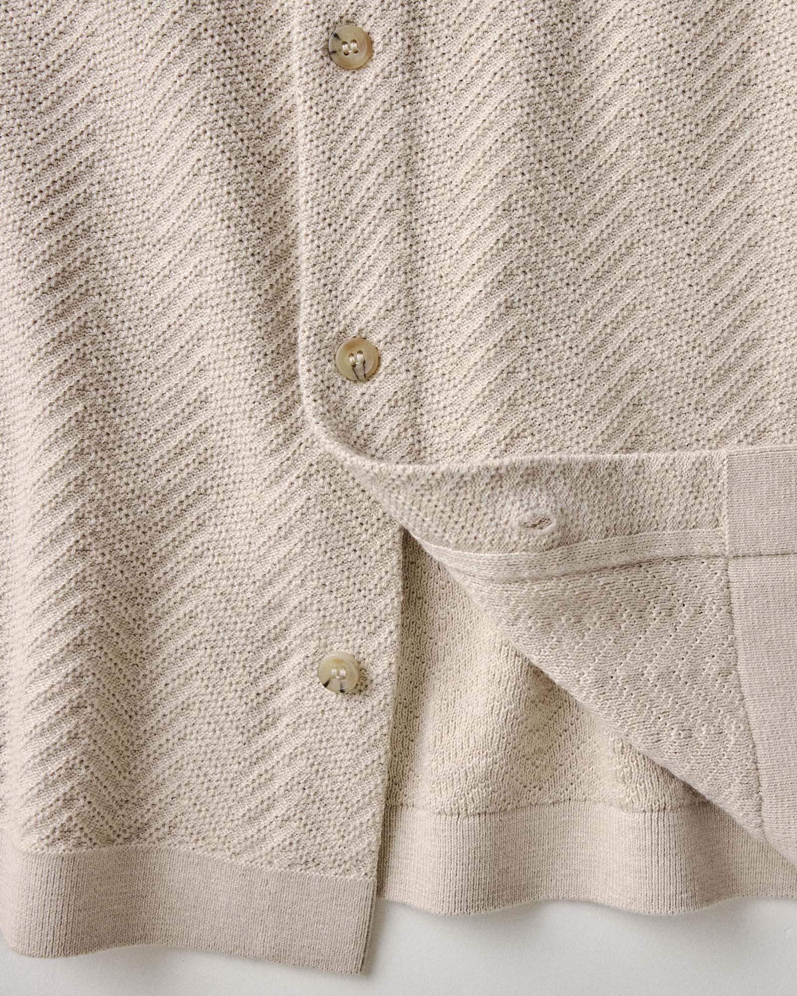 material shot of the buttons on The Button Down Polo in Heather Oat Herringbone, Knits by Taylor Stitch