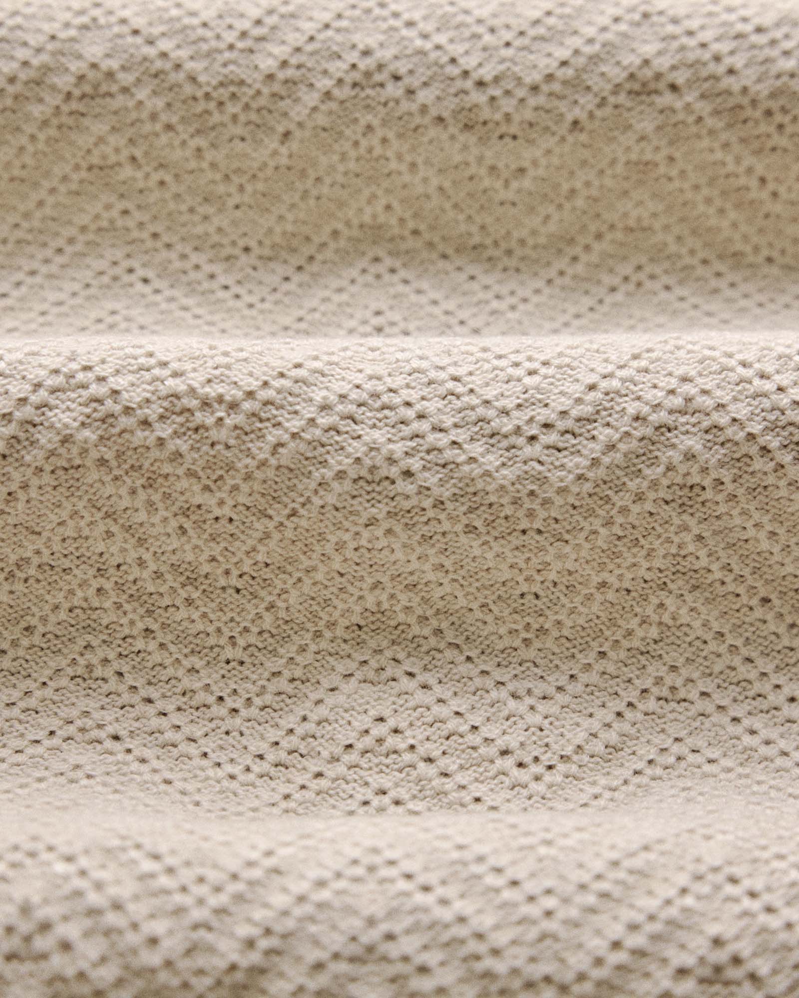 material shot of the fabric on The Button Down Polo in Heather Oat Herringbone, Knits by Taylor Stitch