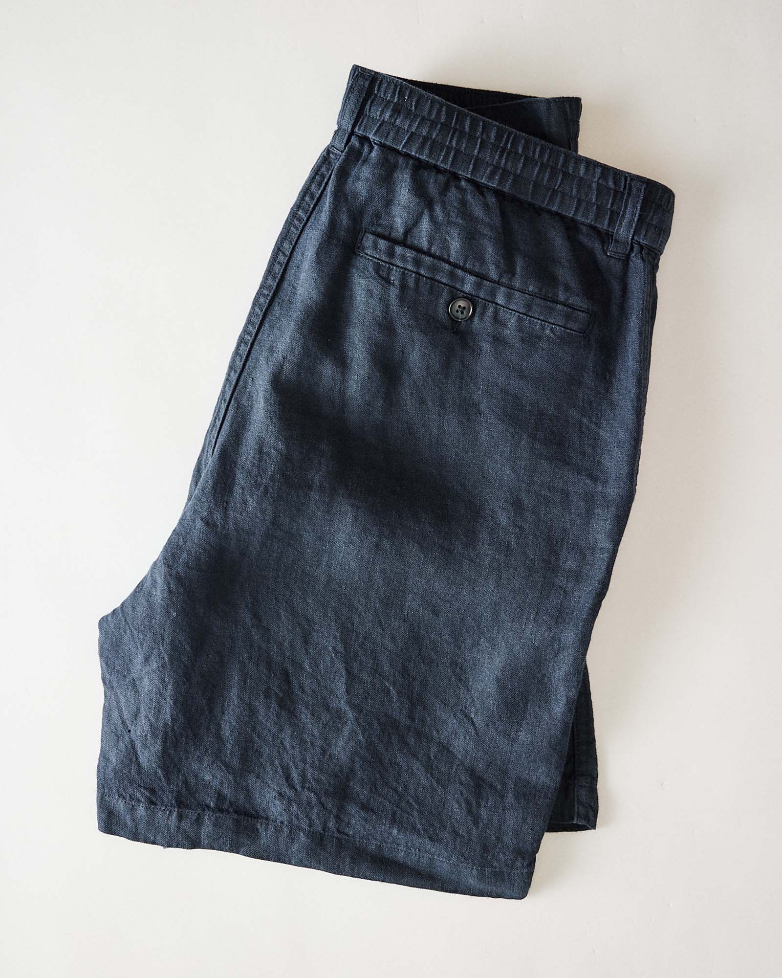 folded flatlay of the back of The Easy Short in Navy Linen, Bottoms by Taylor Stitch