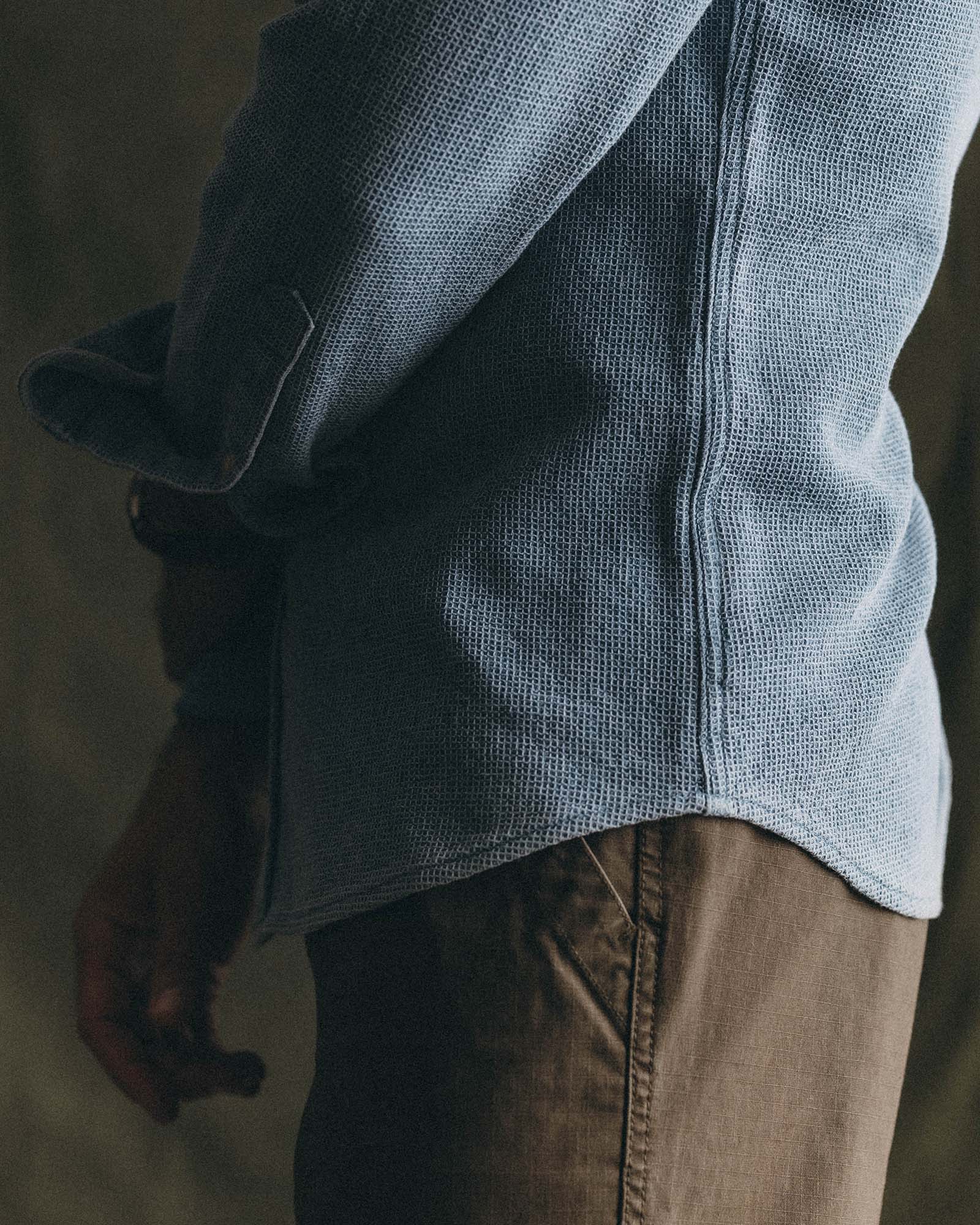 fit model standing on a rock wearing The Jack in Washed Indigo Waffle, Wovens by Taylor Stitch