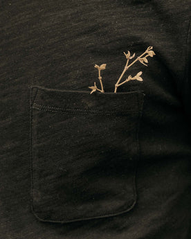 fit model showing off the pocket on The Organic Cotton Tee in Black Indigo, Knits by Taylor Stitch