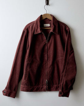 editorial image of The Piston Jacket in Dried Cherry Corduroy hanging, Outerwear by Taylor Stitch