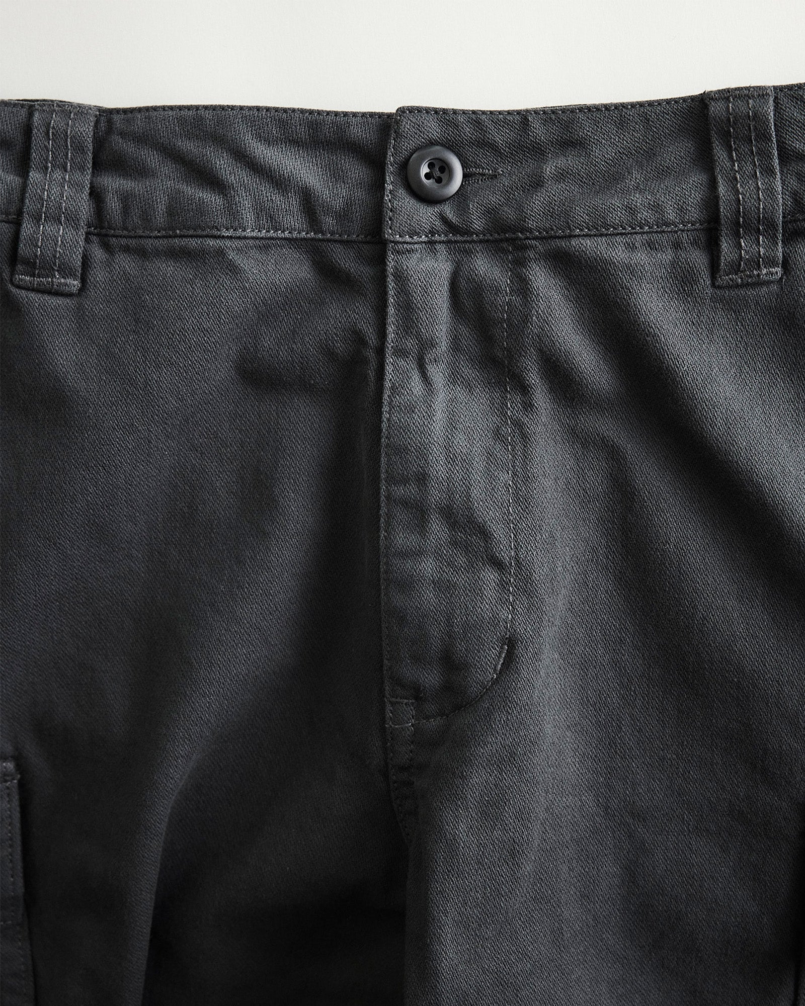 material shot of the button on The Tommie Short in Faded Black Broken Twill, Bottoms by Taylor Stitch