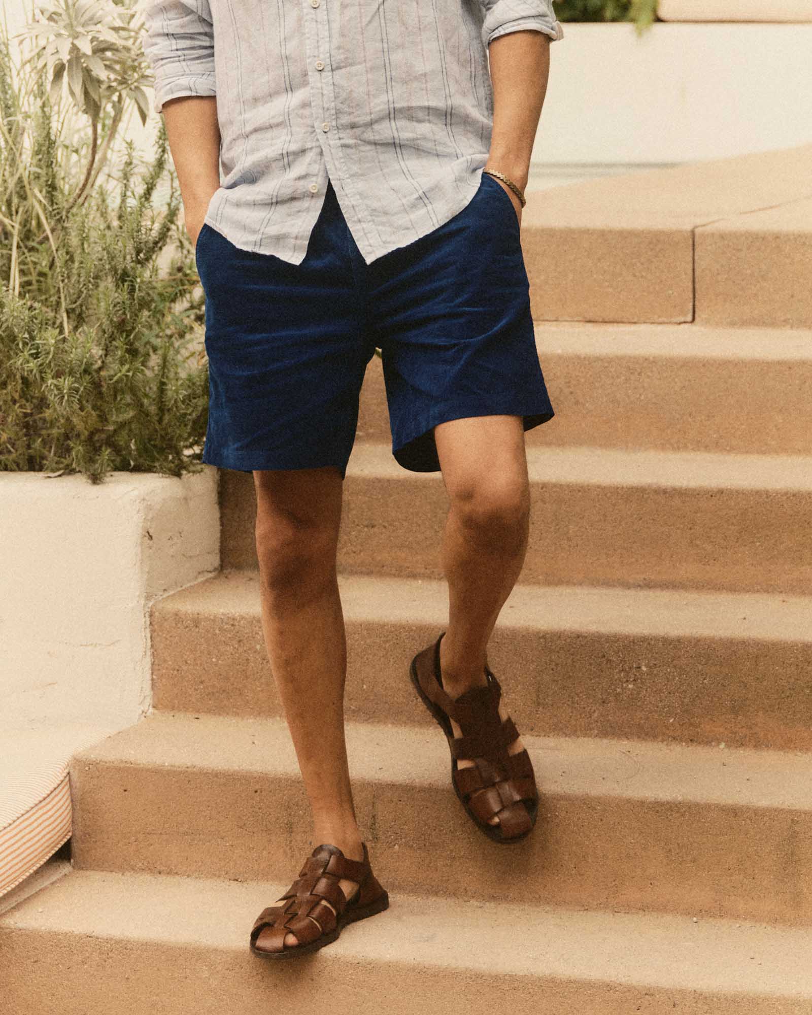 fit model walking wearing The Apres Short in Rinsed Indigo Pincord, Bottoms by Taylor Stitch