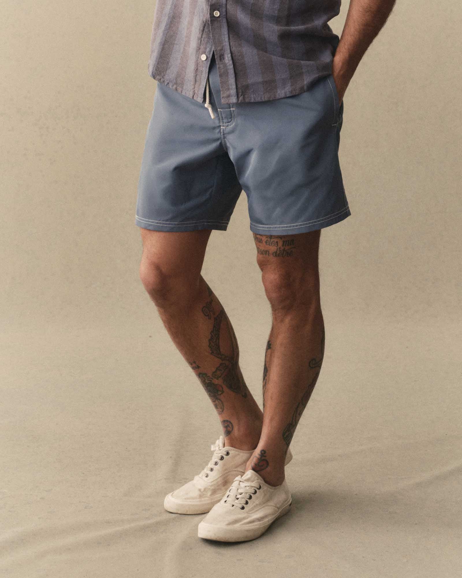 fit model showing off The Drift Boardshort in Bluefin, Bottoms by Taylor Stitch