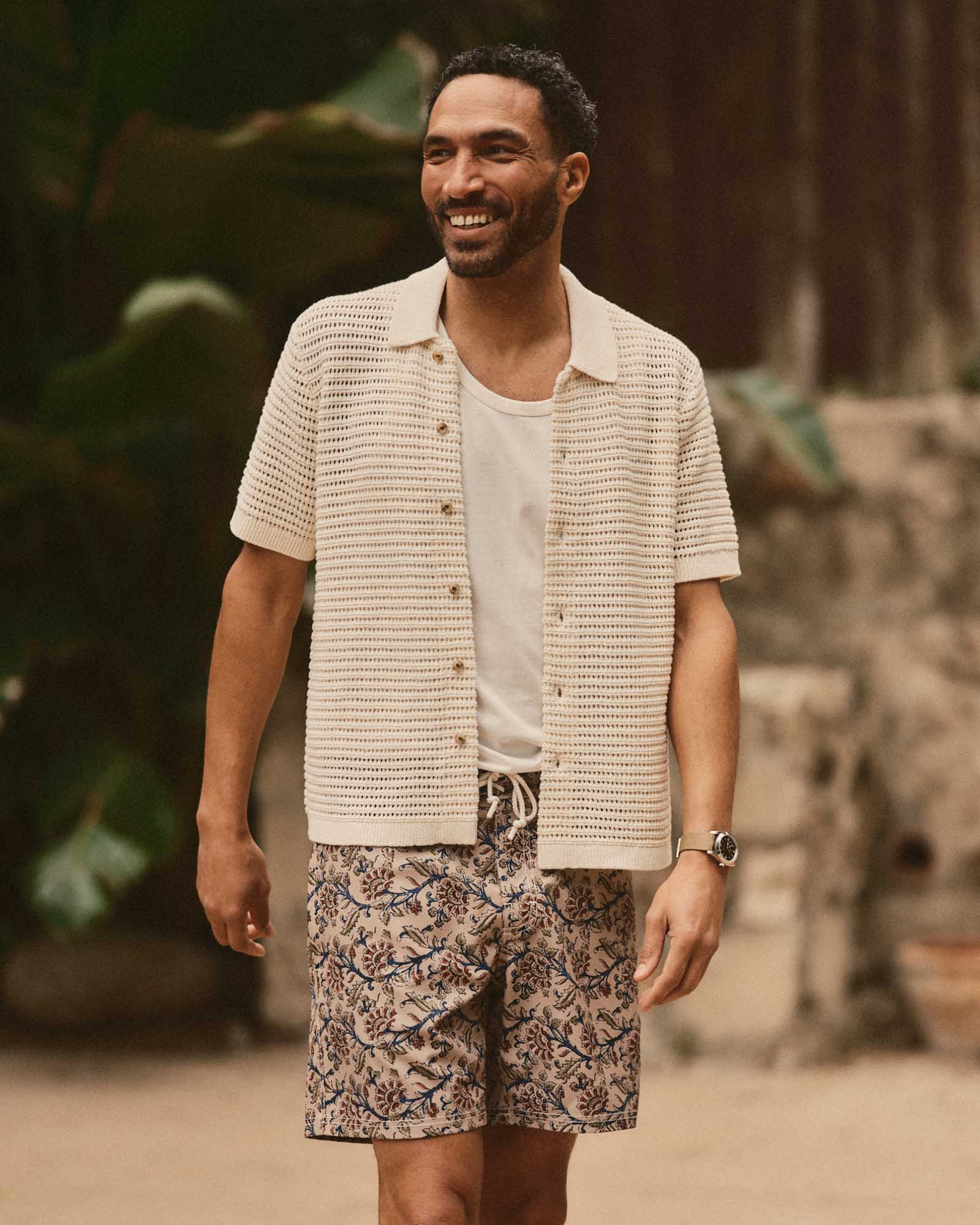 fit model walking wearing The Drift Boardshort in Ivory Floral, Bottoms by Taylor Stitch