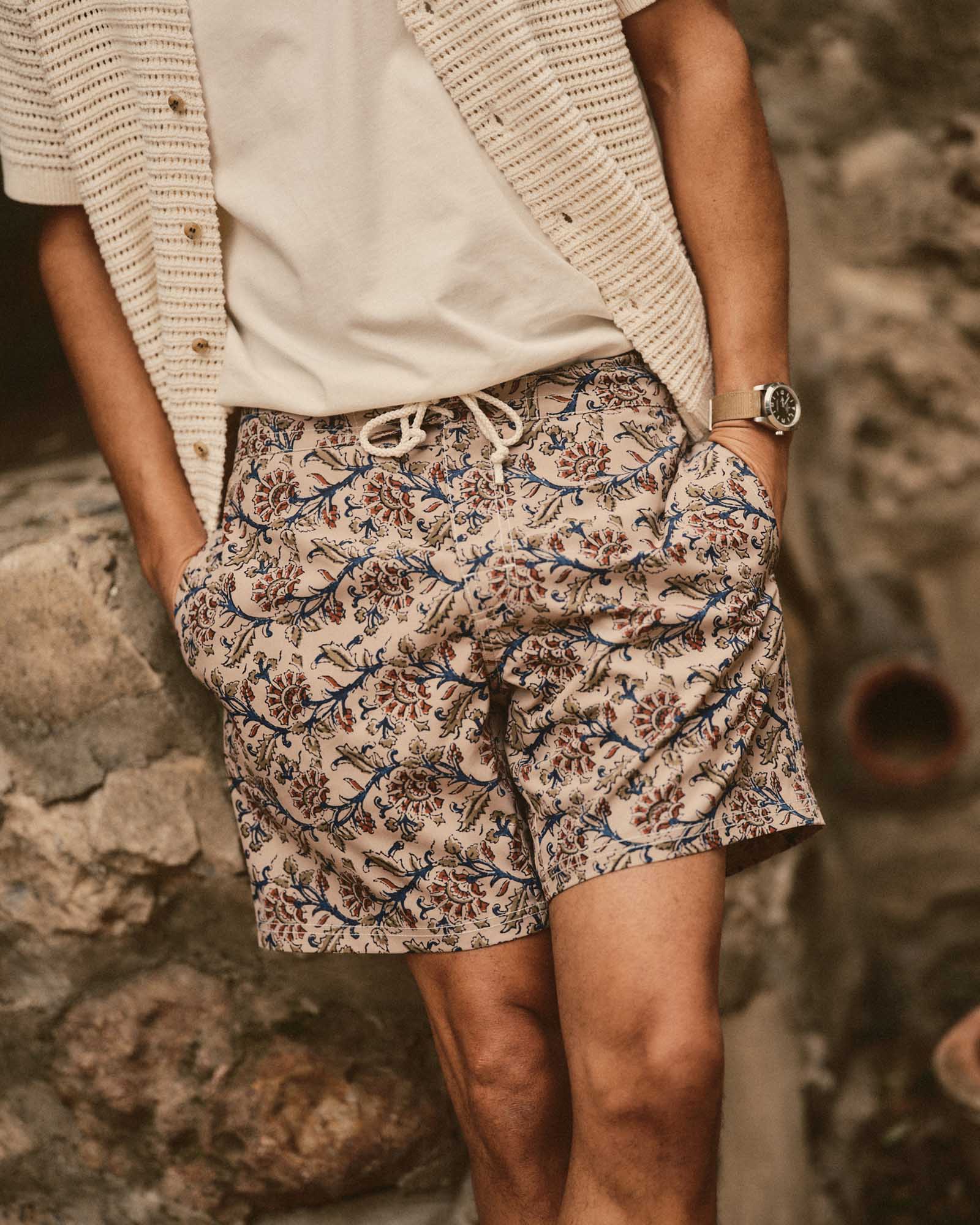 fit model posing in The Drift Boardshort in Ivory Floral, Bottoms by Taylor Stitch