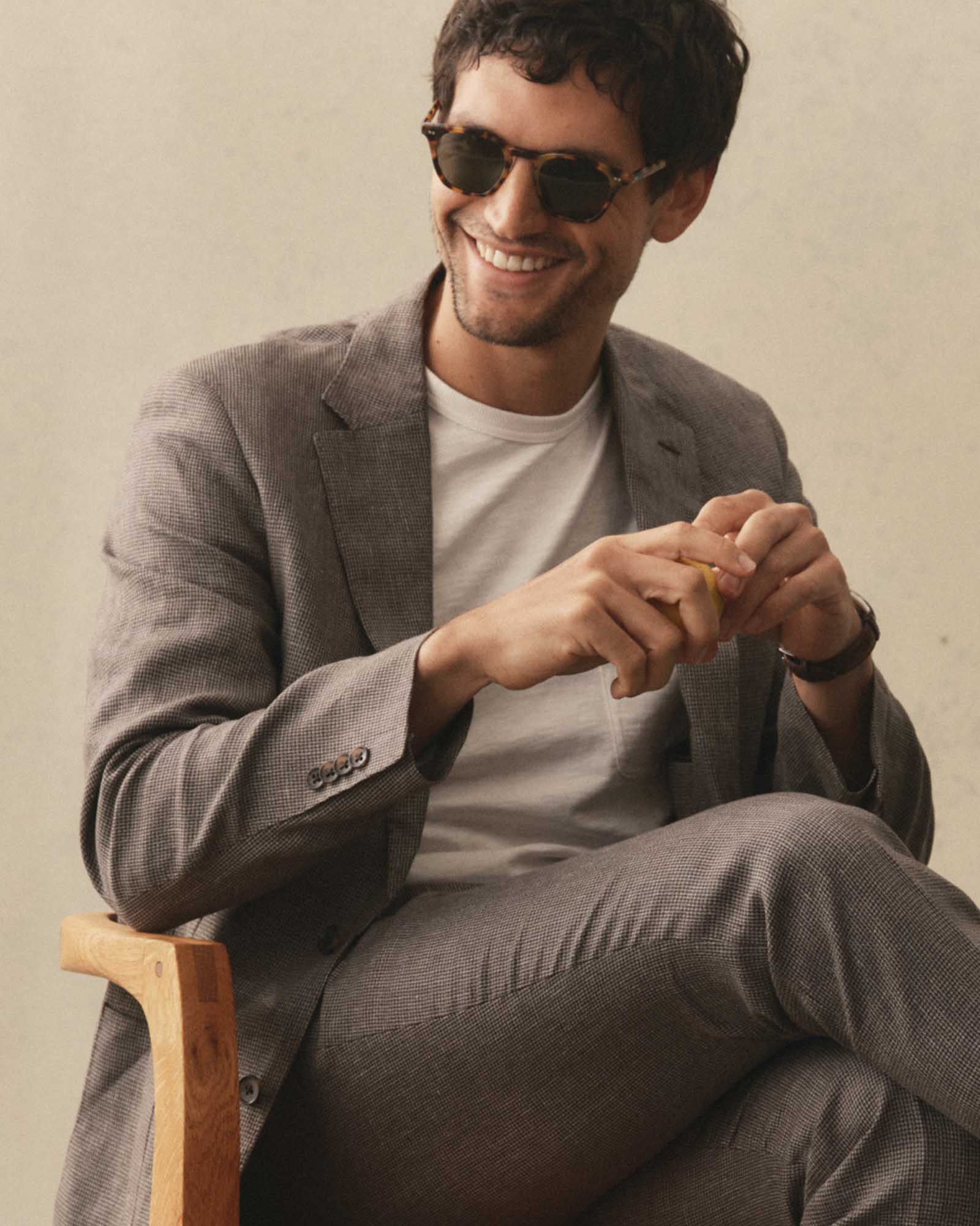 fit model sitting wearing The Legend in Tokyo Tortoise, Accessories by Taylor Stitch