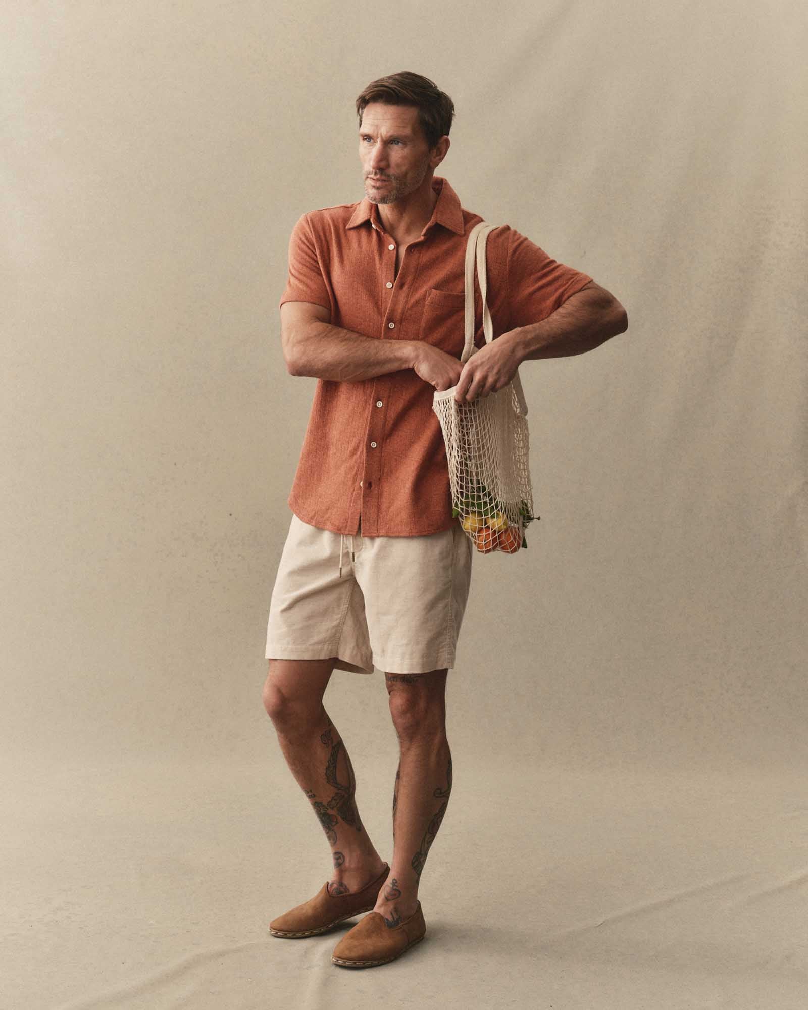 fit model posing in The Short Sleeve California in Heather Driftwood Double Knit, Knits by Taylor Stitch