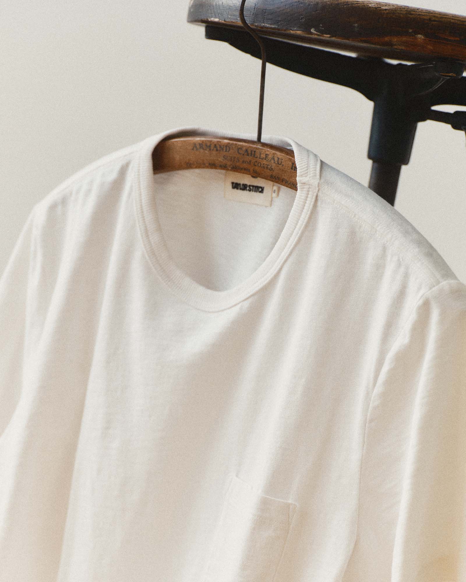 editorial image of the collar on The Slub Tee in White hanging, Knits by Taylor Stitch
