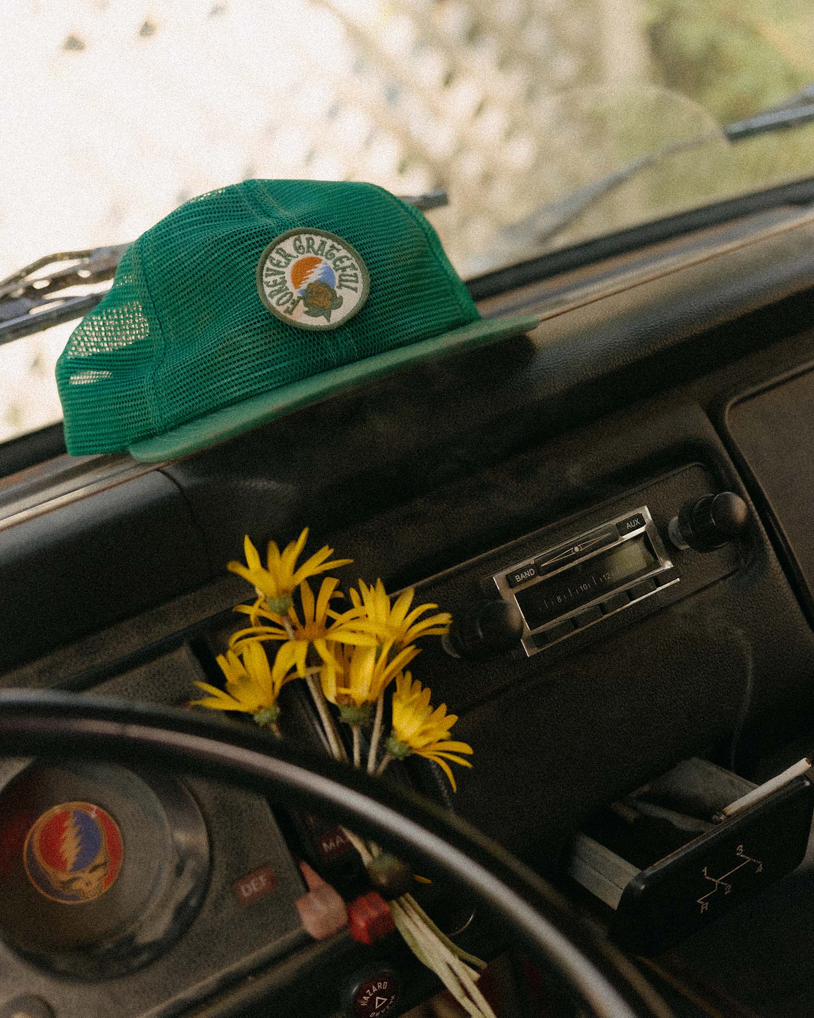 editorial image of The 6-Panel Trucker Cap in Emerald Mesh on a car, Accessories by Taylor Stitch