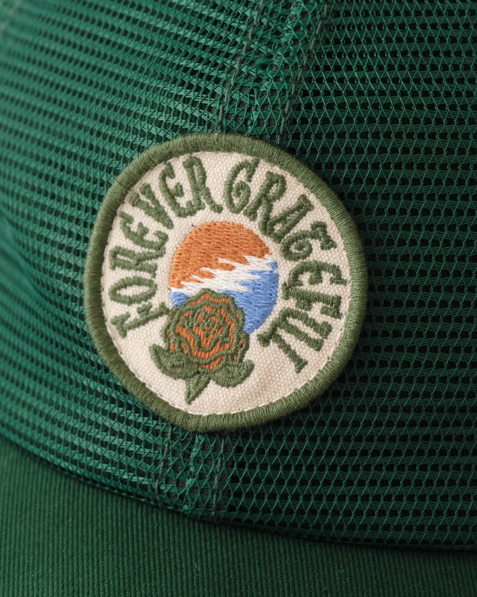 editorial image of the patch on The 6-Panel Trucker Cap in Emerald Mesh, Accessories by Taylor Stitch