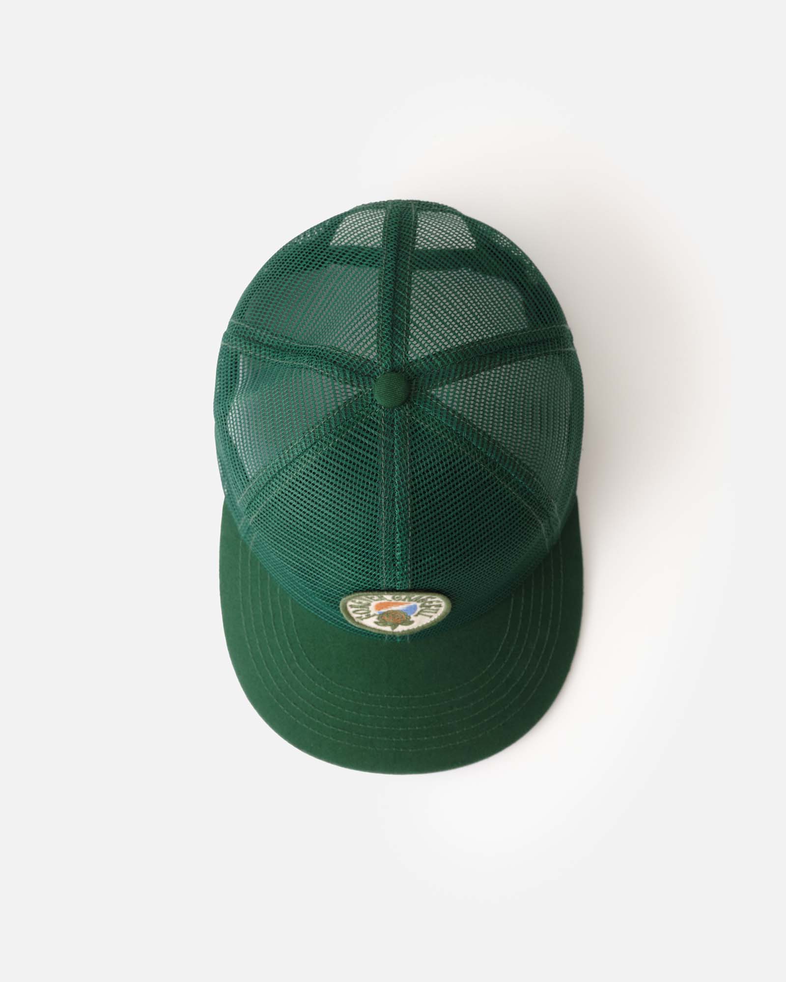 flatlay of the top of The 6-Panel Trucker Cap in Emerald Mesh, Accessories by Taylor Stitch