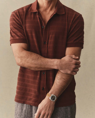 fit model posing in The Bywater Polo in Burgundy Knit Stripe