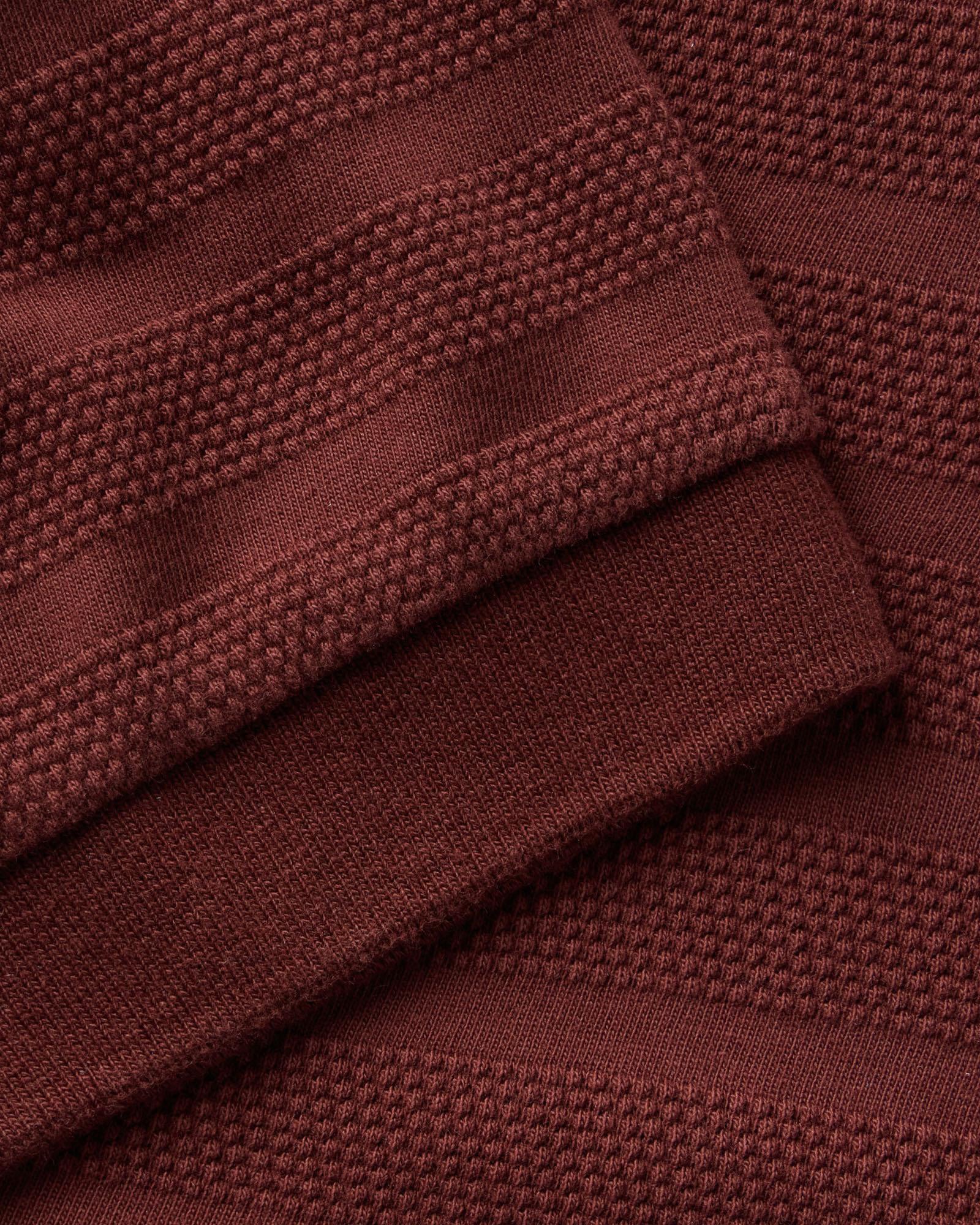 material shot of the sleeve on The Bywater Polo in Burgundy Knit Stripe, Knits by Taylor Stitch