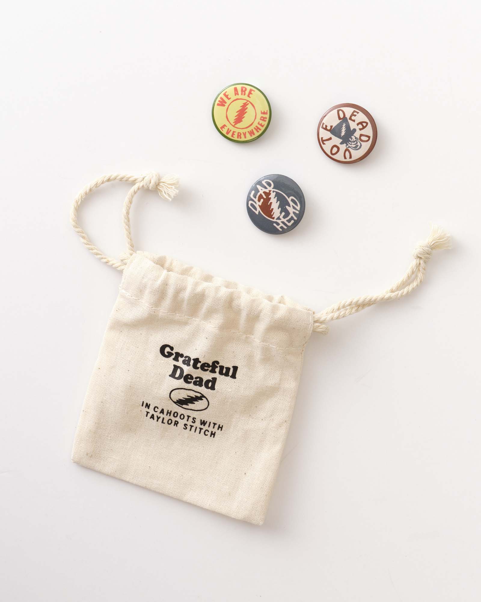 editorial image of The Acid Test Pin Set next to a bag, Accessories by Taylor Stitch
