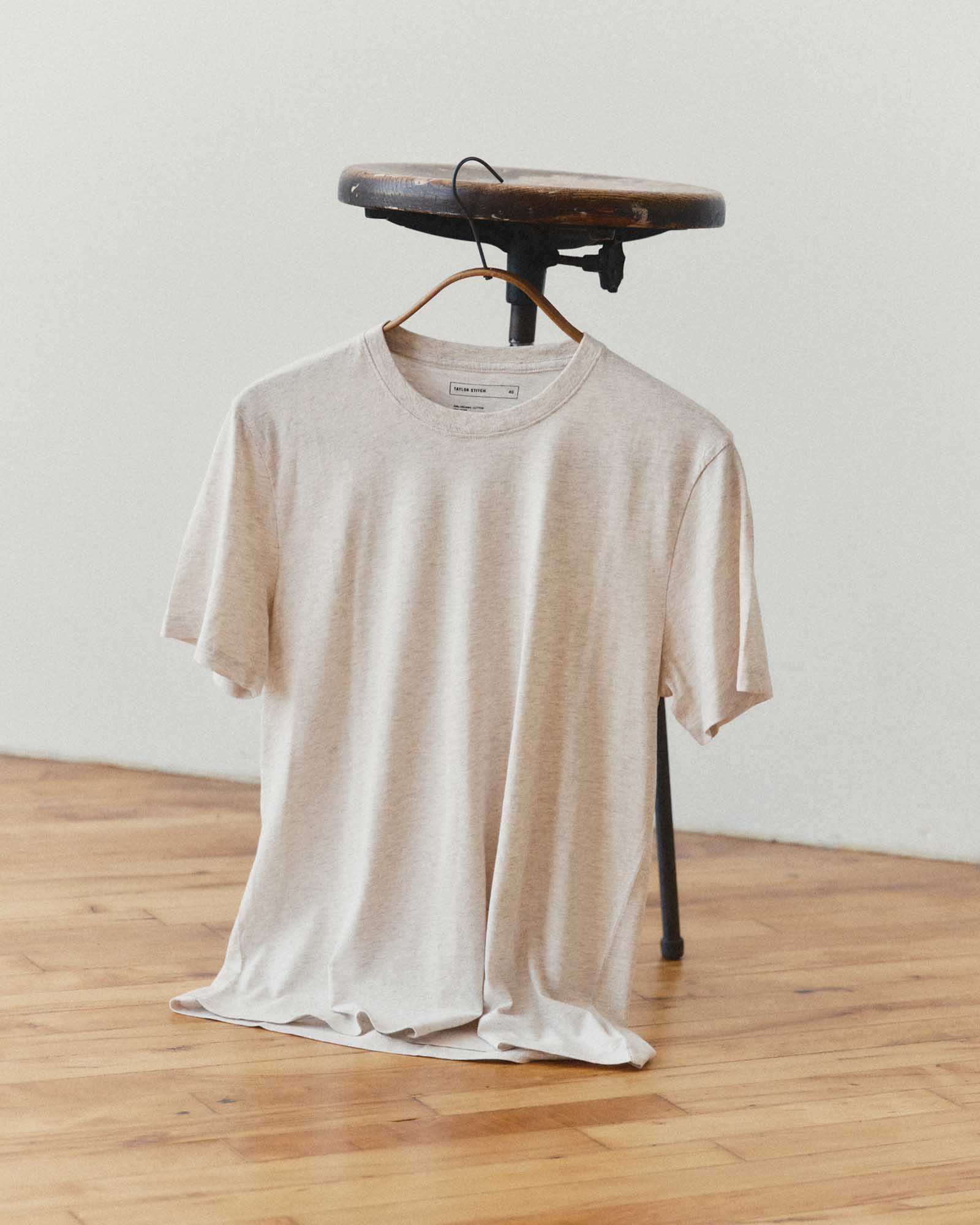 editorial image of The Cotton Hemp Tee in Heather Oat on a stool, Knits by Taylor Stitch