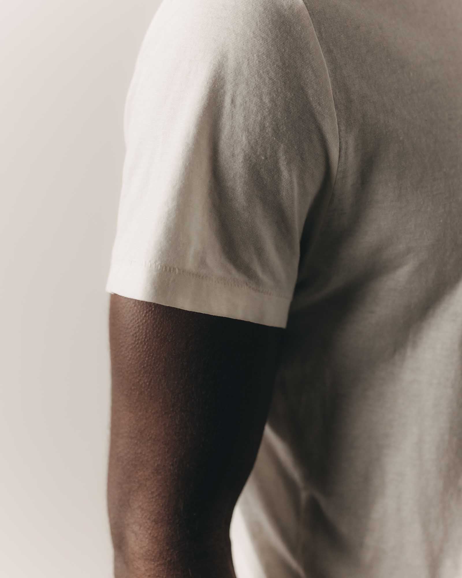 fit model showing off the sleeves on The Cotton Hemp Tee in Vintage White, Knits by Taylor Stitch