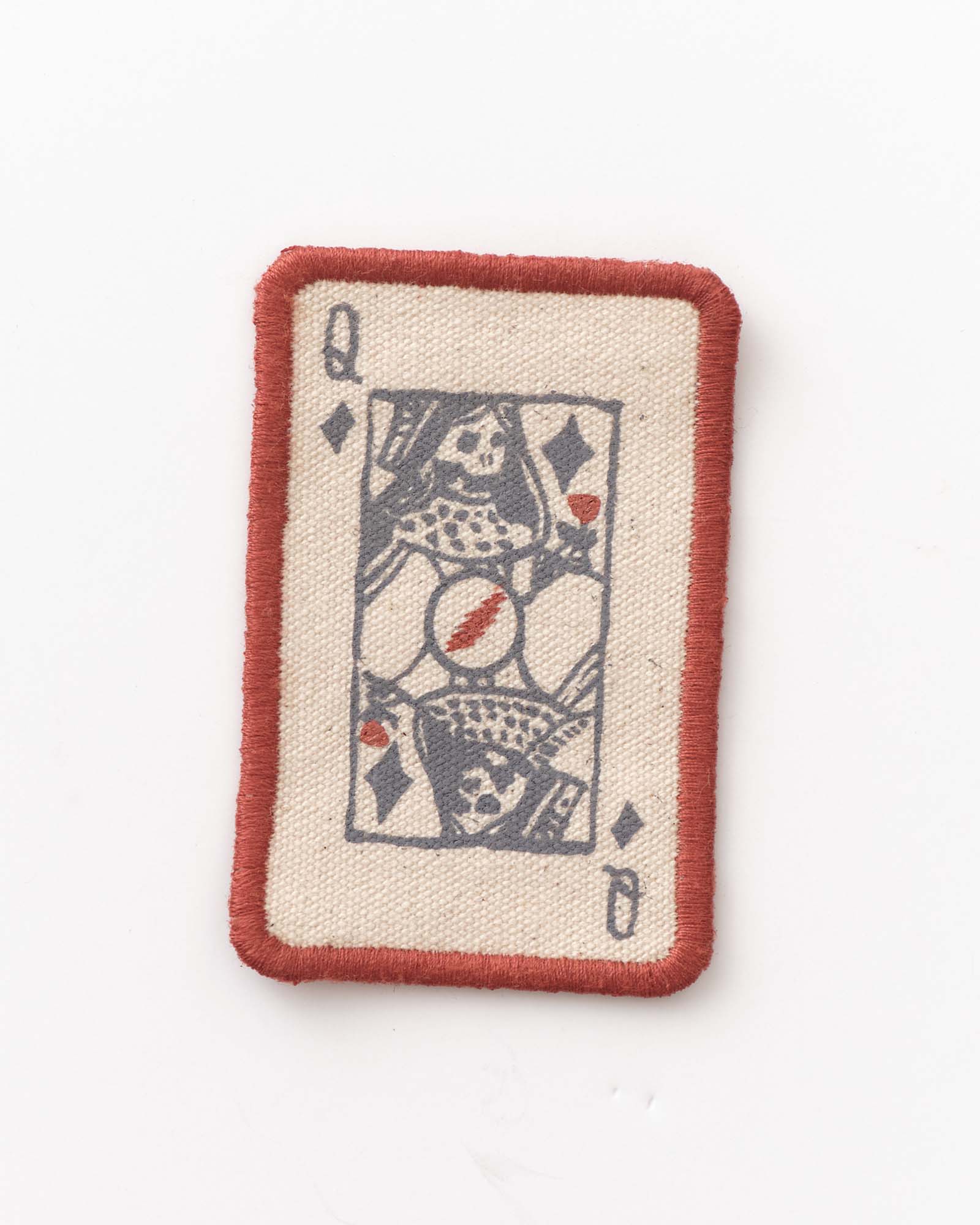 Fabric patch with a Queen of Spades card design on a white background, Accessories by Taylor Stitch