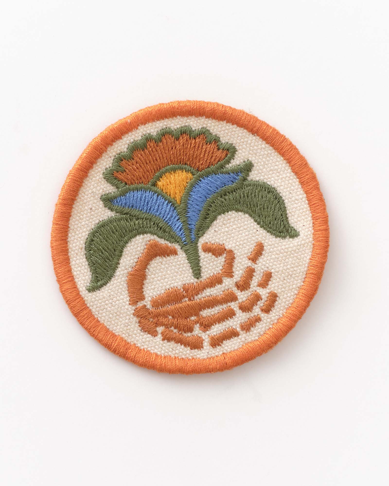 Circular embroidered patch with floral design on a white background, Accessories by Taylor Stitch