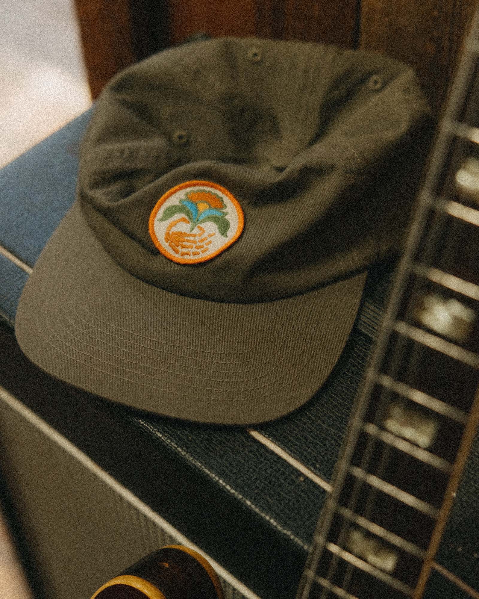 editorial image of The Mercer Cap in Bud Green Twill on an amp, Accessories by Taylor Stitch
