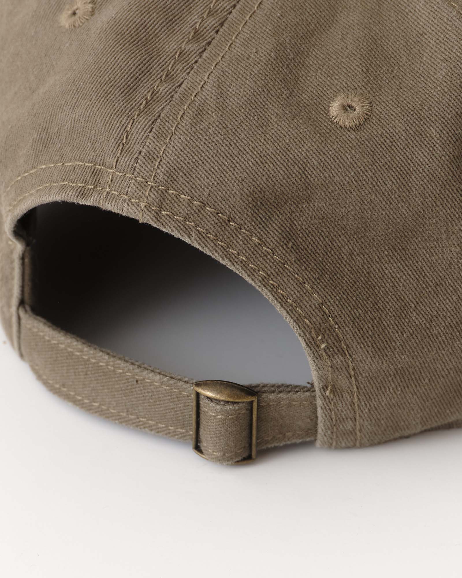 editorial image of the back strap on The Mercer Cap in Bud Green Twill, Accessories by Taylor Stitch