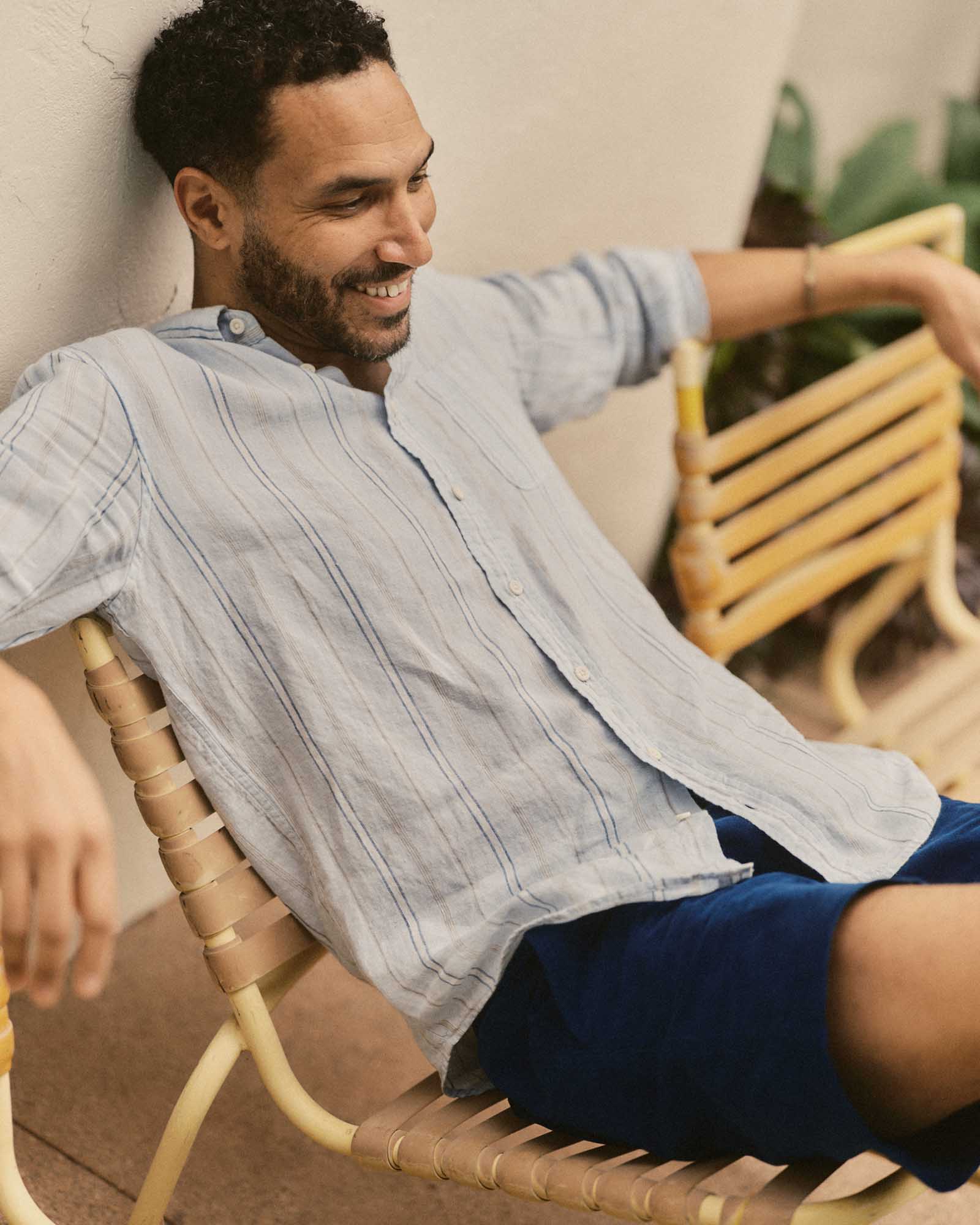fit model sitting wearing The Jack in Blue Sky Stripe Linen, Wovens by Taylor Stitch