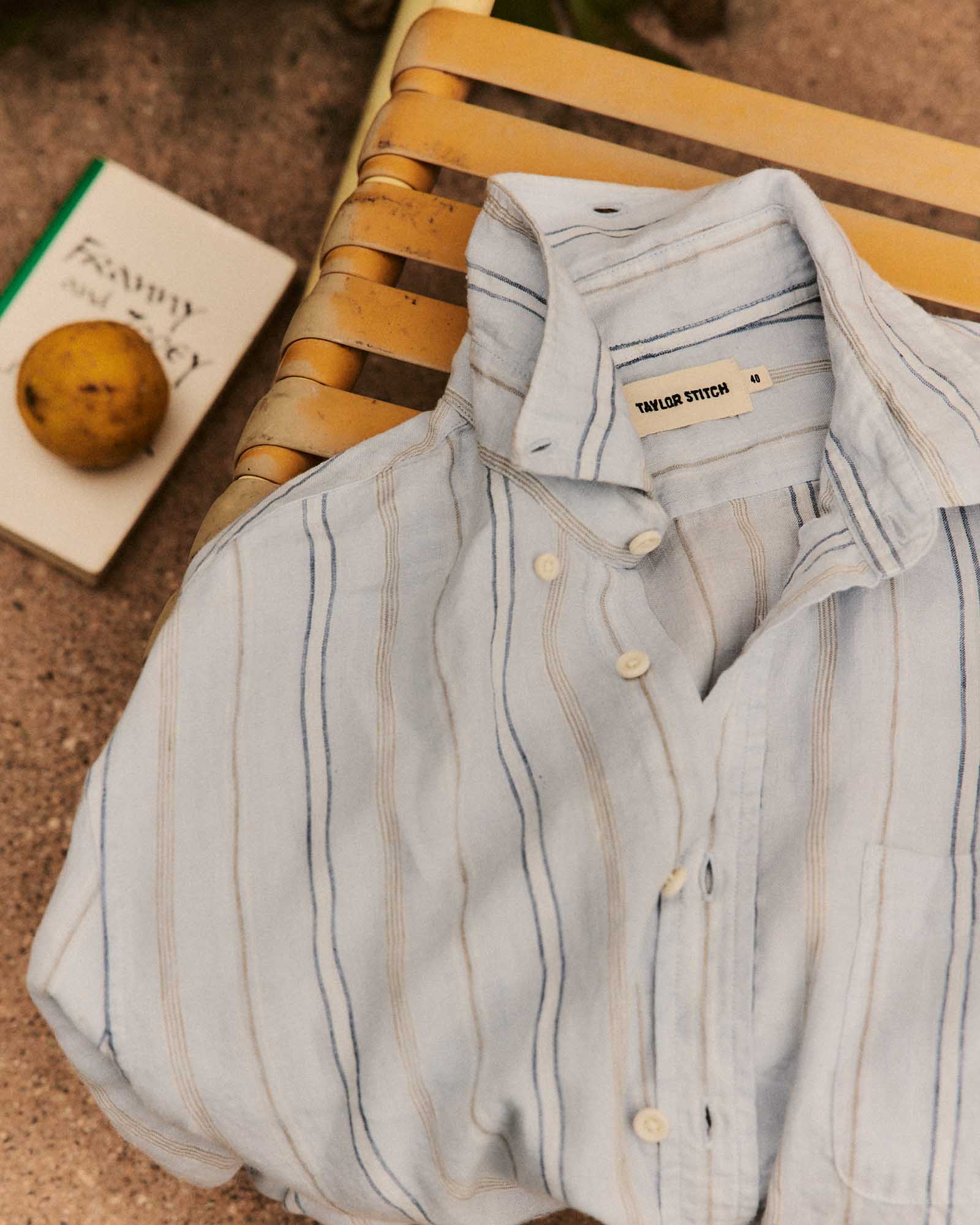 editorial flatlay of The Jack in Blue Sky Stripe Linen, Wovens by Taylor Stitch