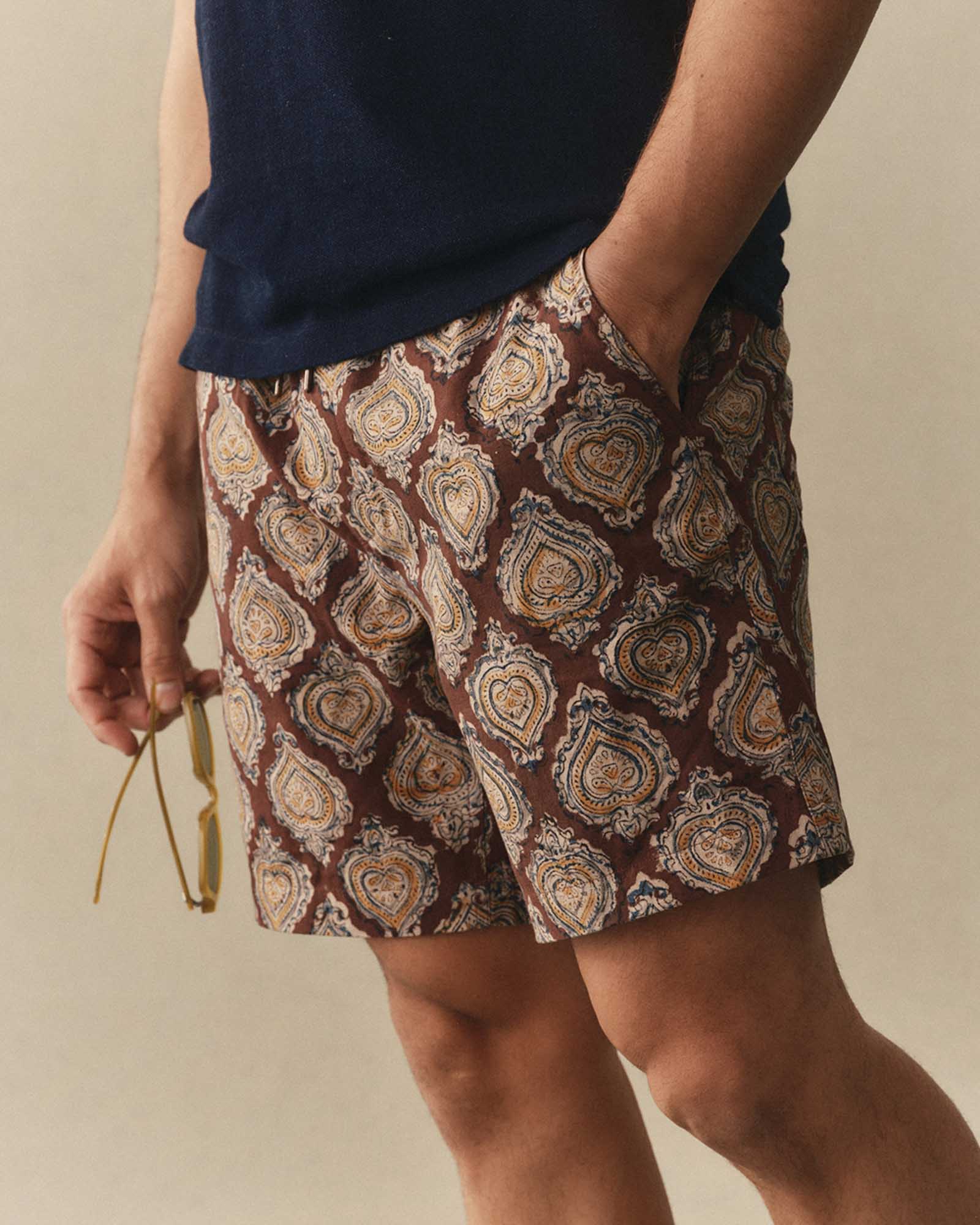 fit model with his hand in his pocket wearing The Apres Short in Sangria Block Print, Bottoms by Taylor Stitch